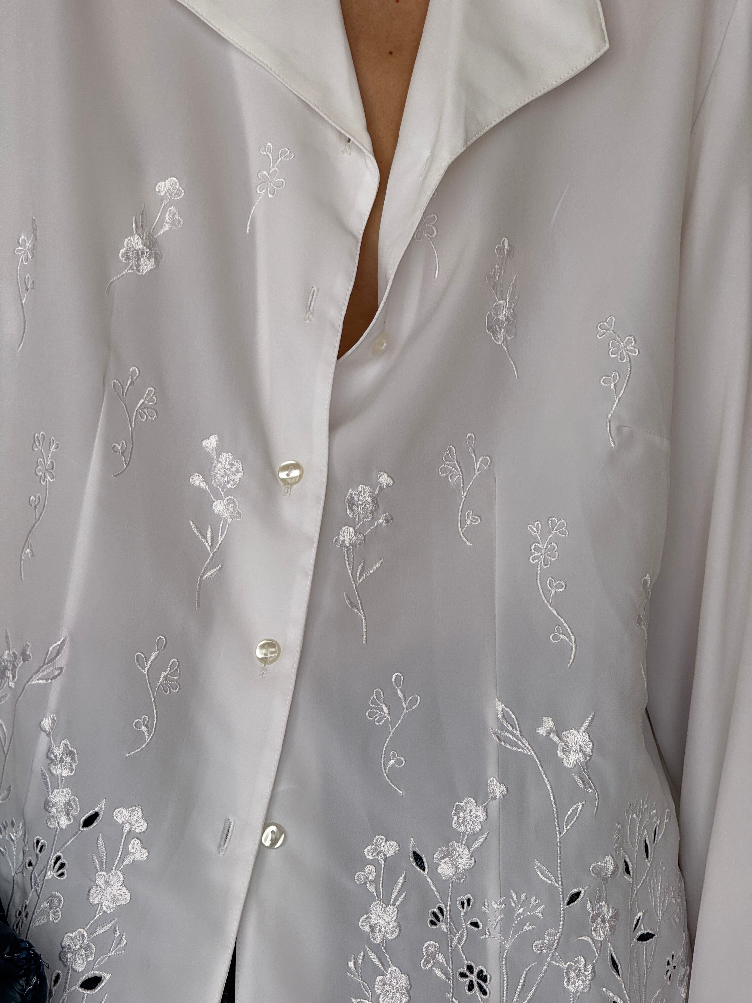 Vintage white embroidered blouse fabric close-up