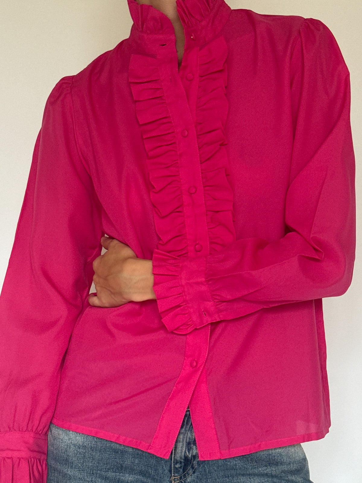 Front view of vintage fuchsia ruffle blouse with fabric-covered buttons