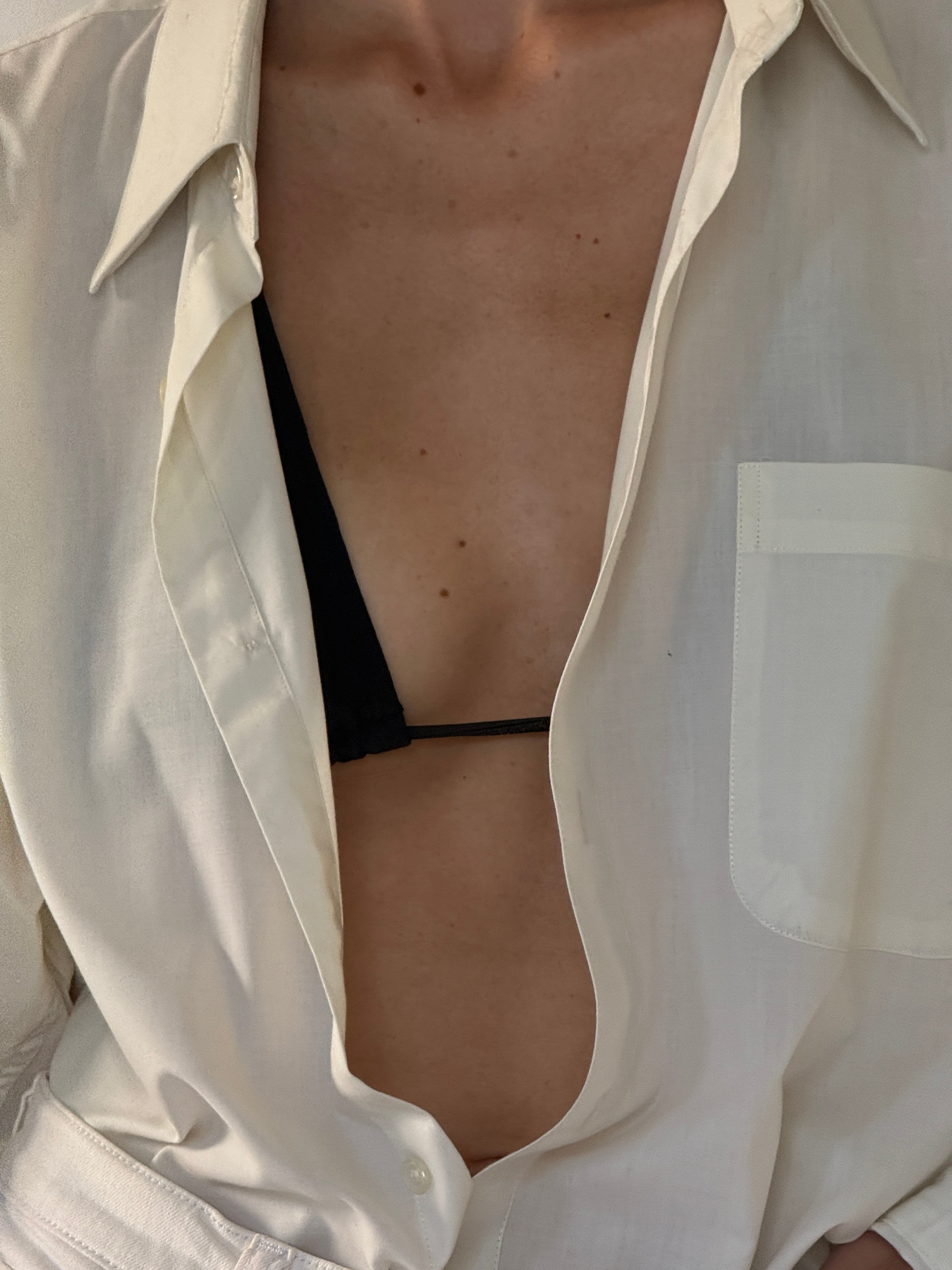 Vintage oversized off-white shirt fabric close-up