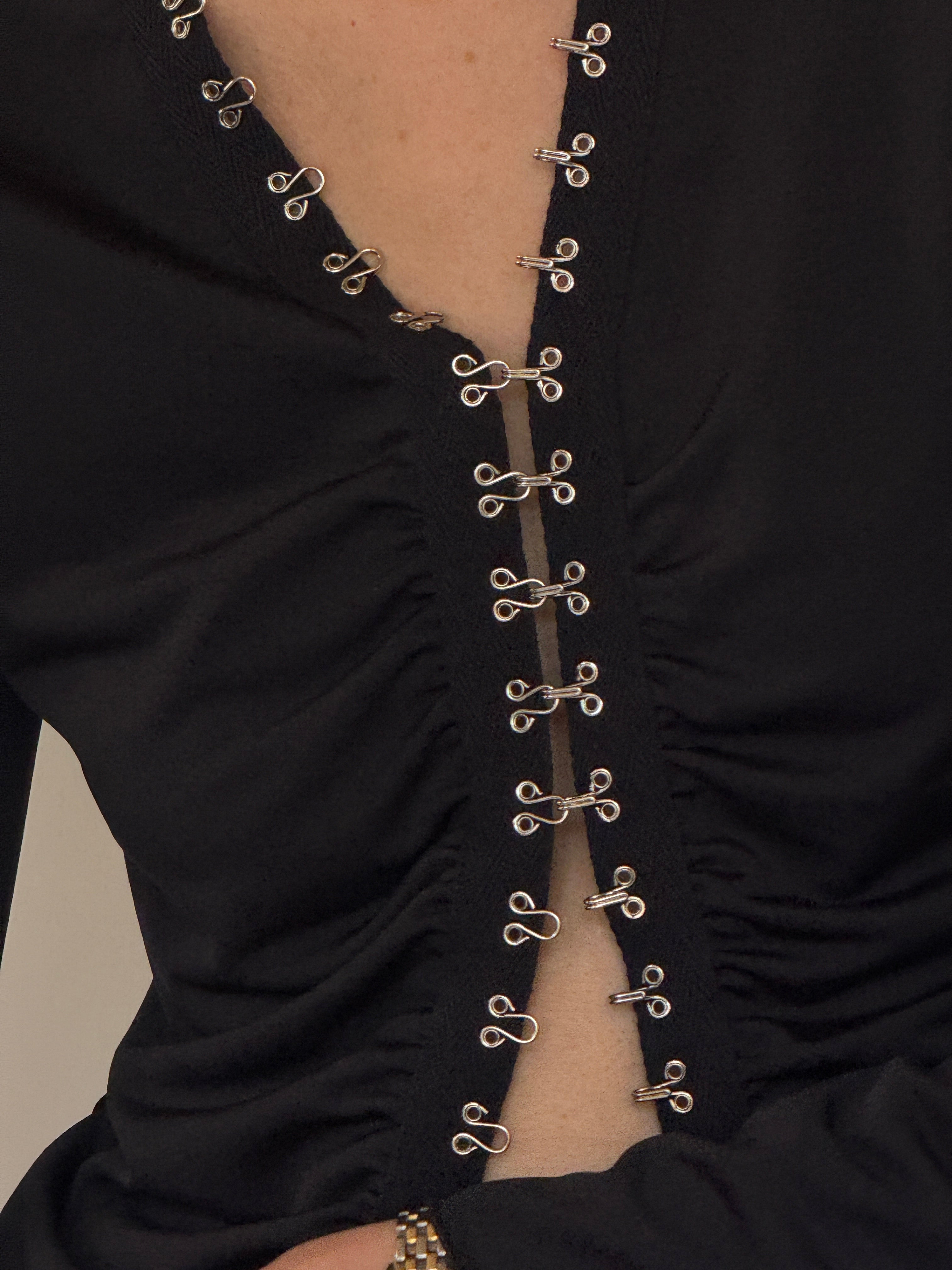 Vintage black hook front ruched blouse neckline hook detail close-up