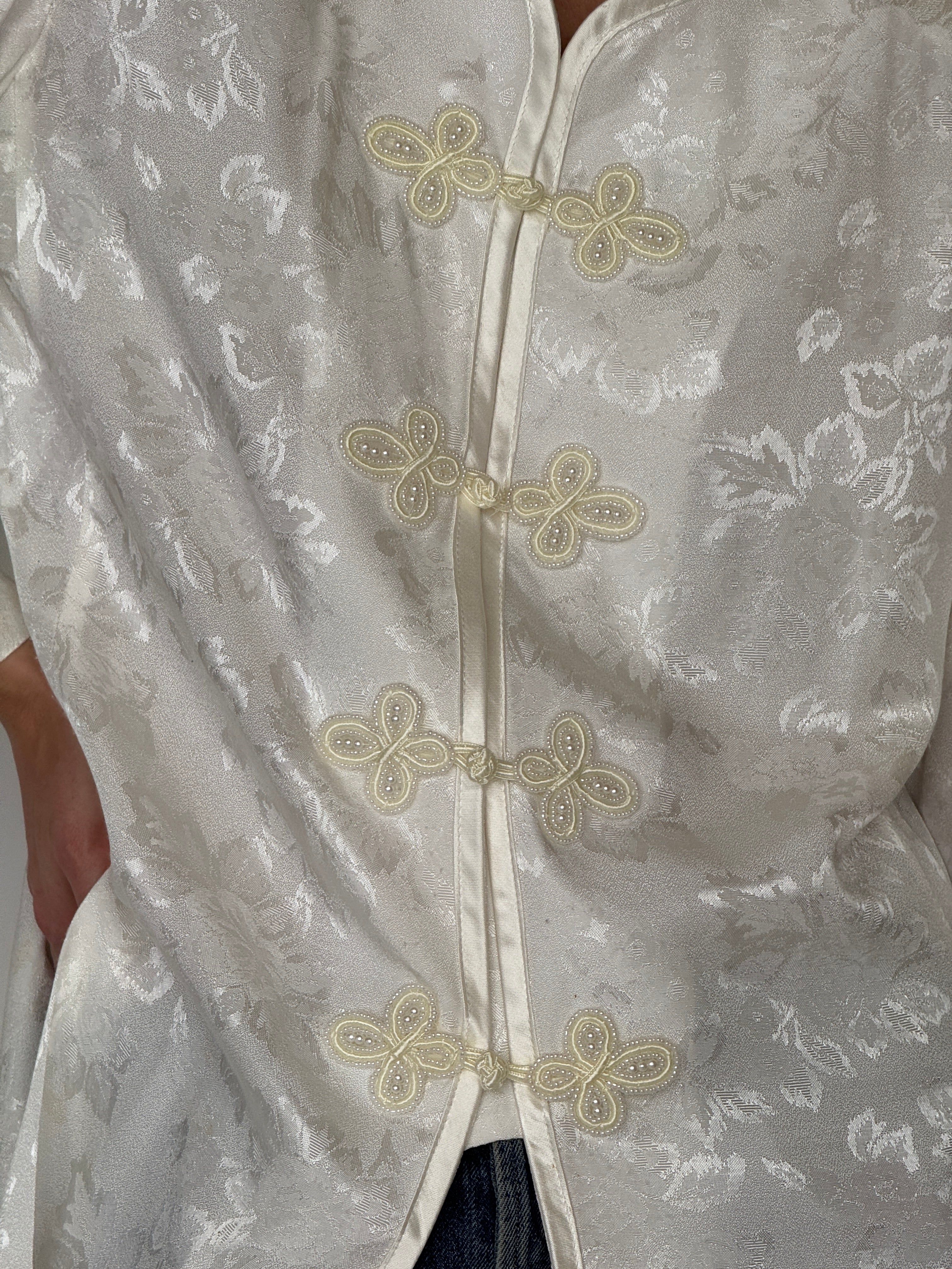 Vintage ivory jacquard frog closure jacket fabric close-up