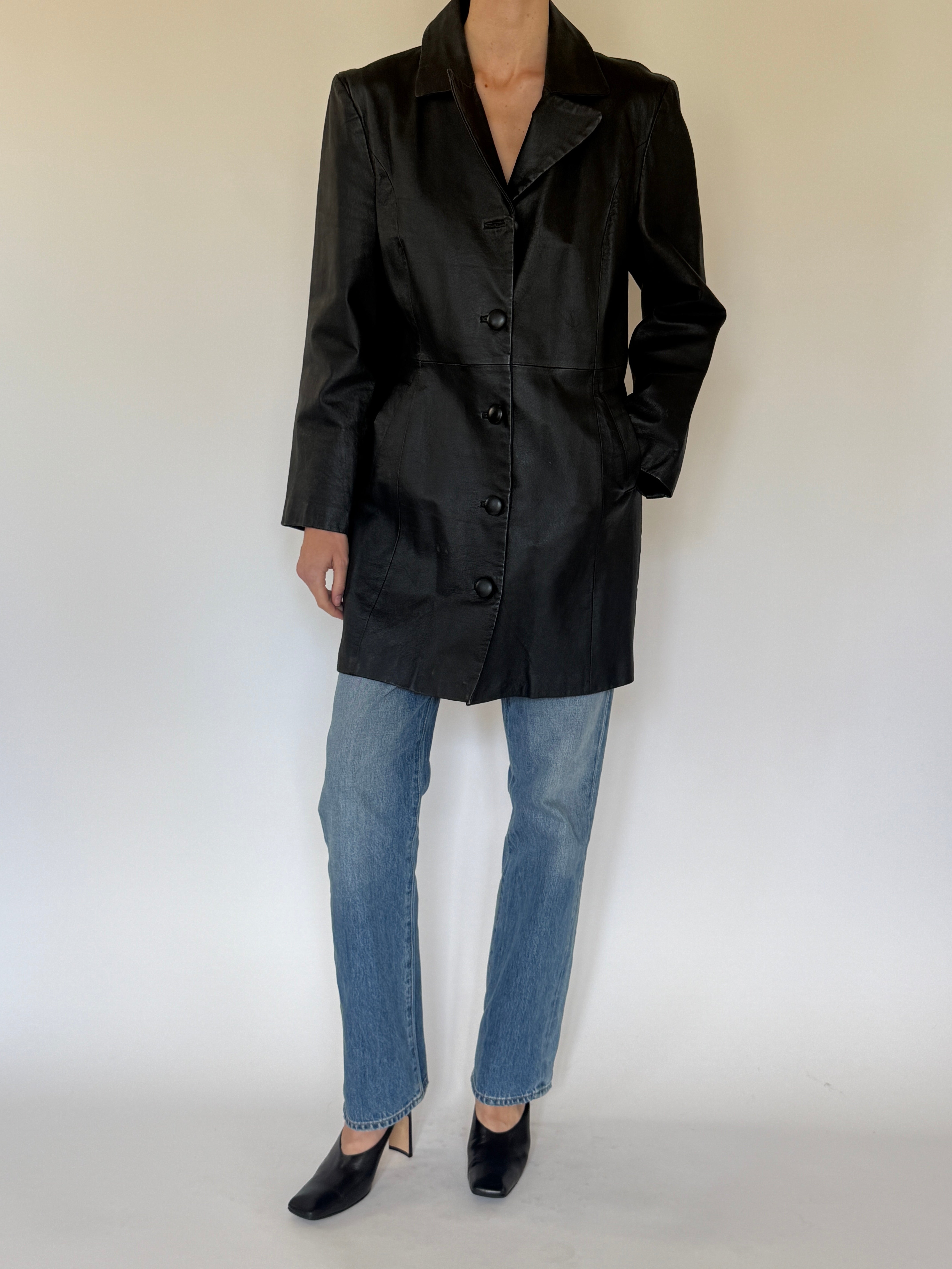 Vintage black leather coat front view with button closure