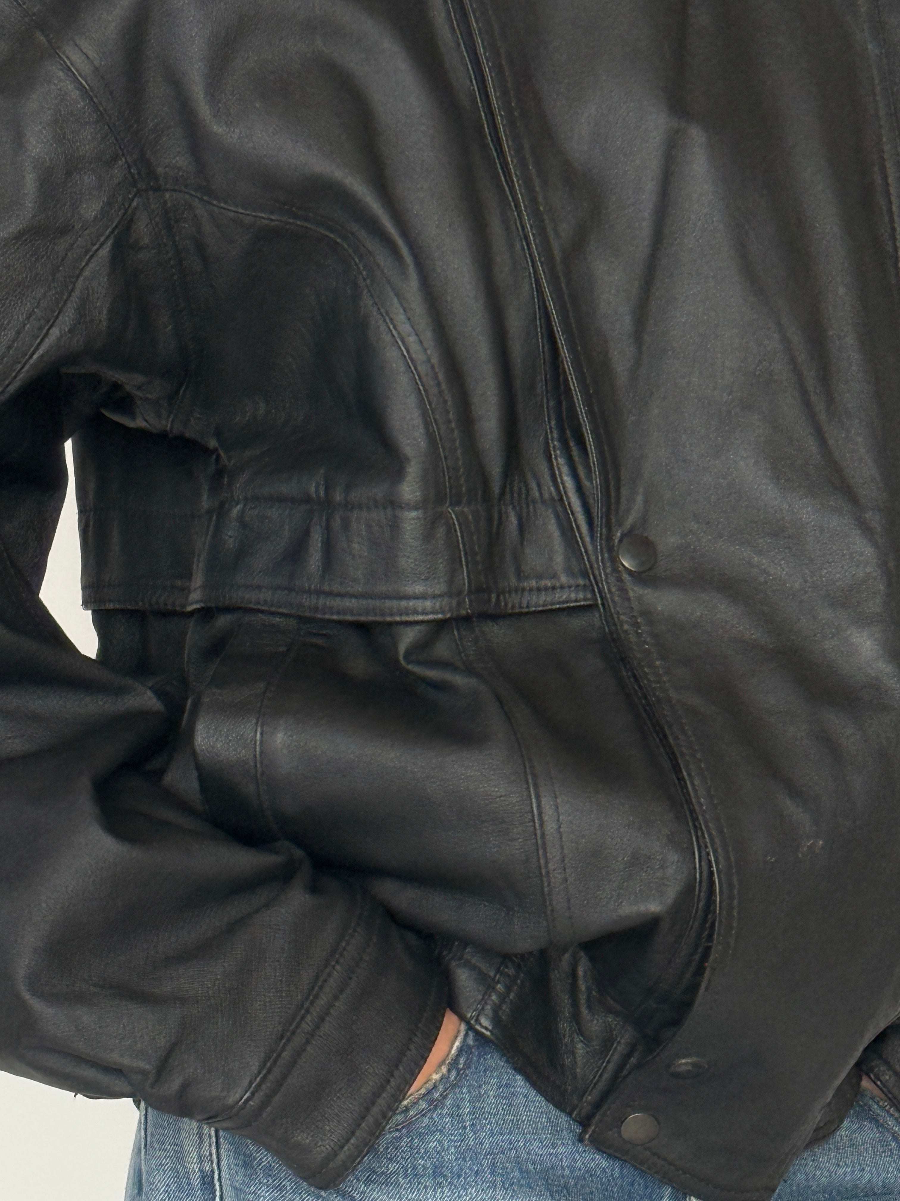 Vintage black leather jacket chest pocket detail