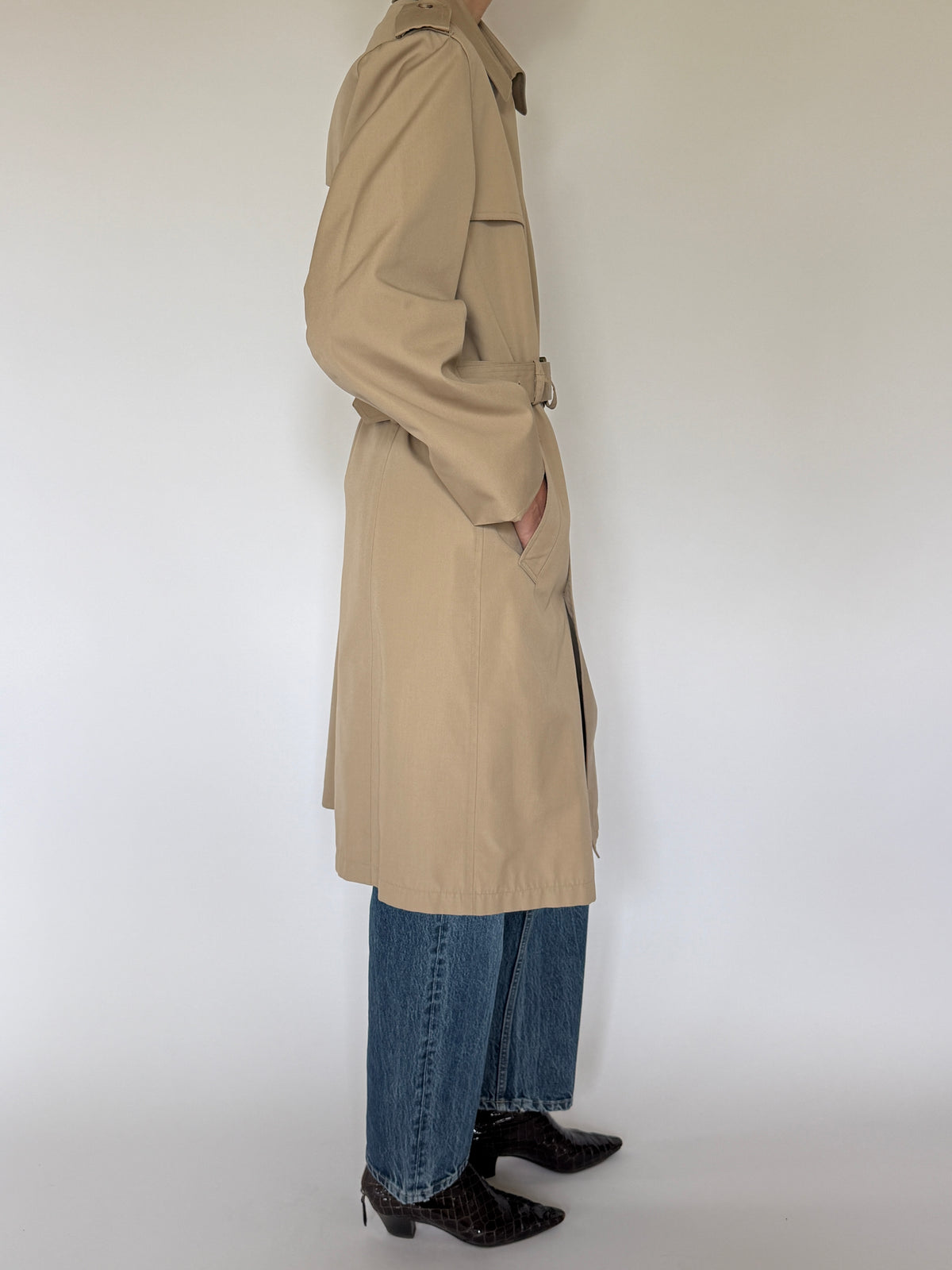 Vintage tan trench coat side view showing long silhouette and angled pocket
