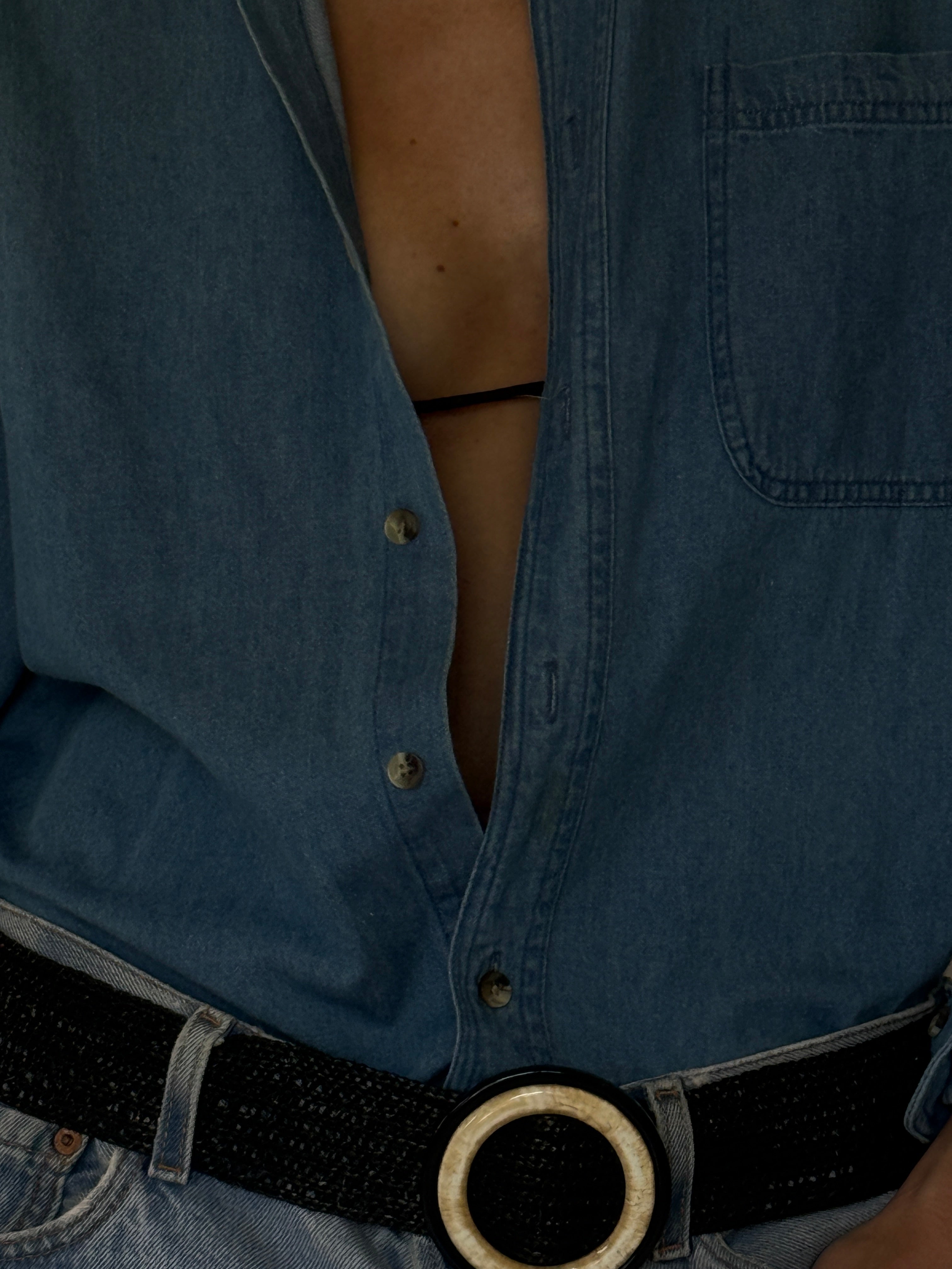 Vintage oversized blue denim shirt fabric close-up