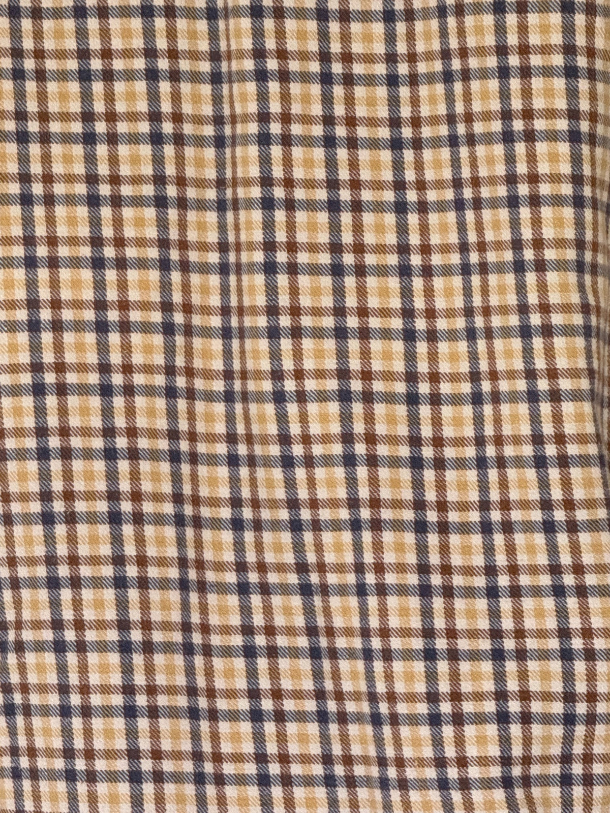 Vintage plaid cotton shirt fabric close-up in beige brown and navy
