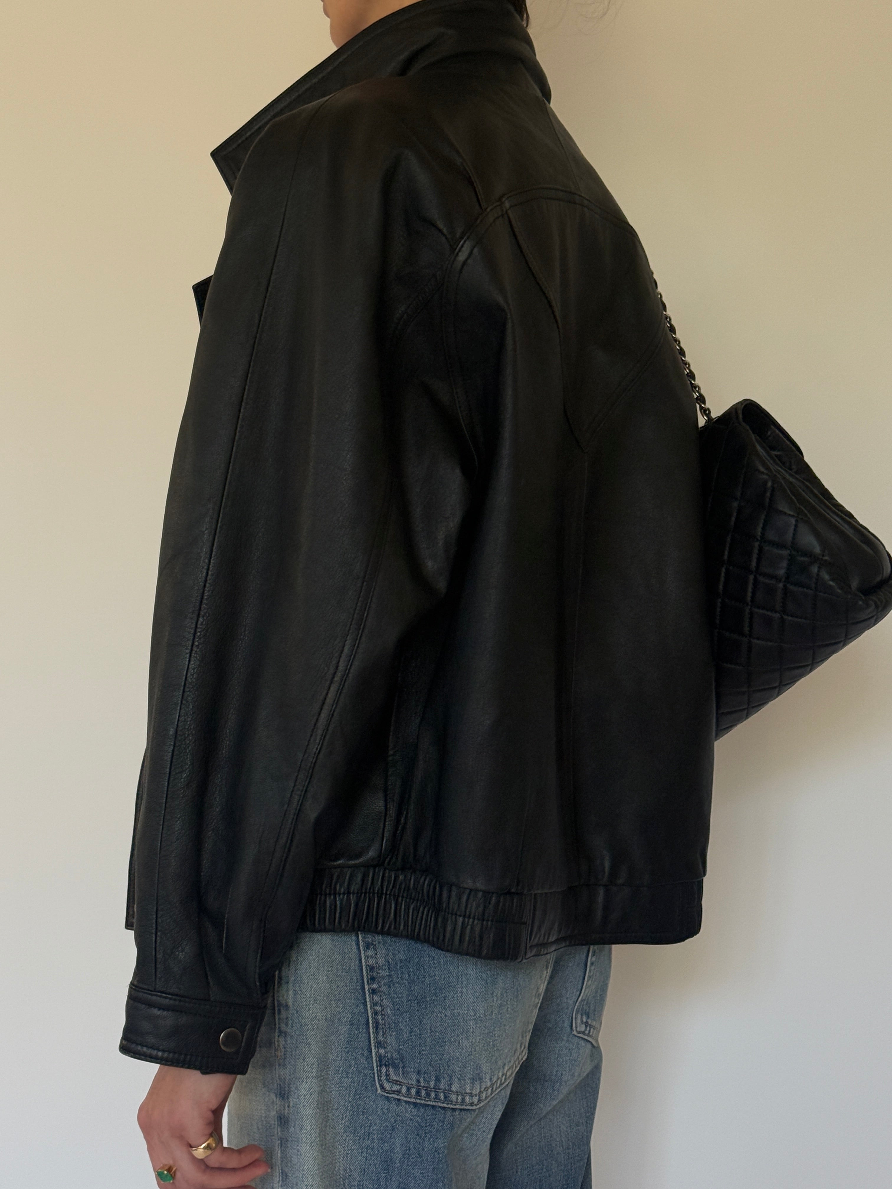 Vintage oversized black leather bomber jacket side view
