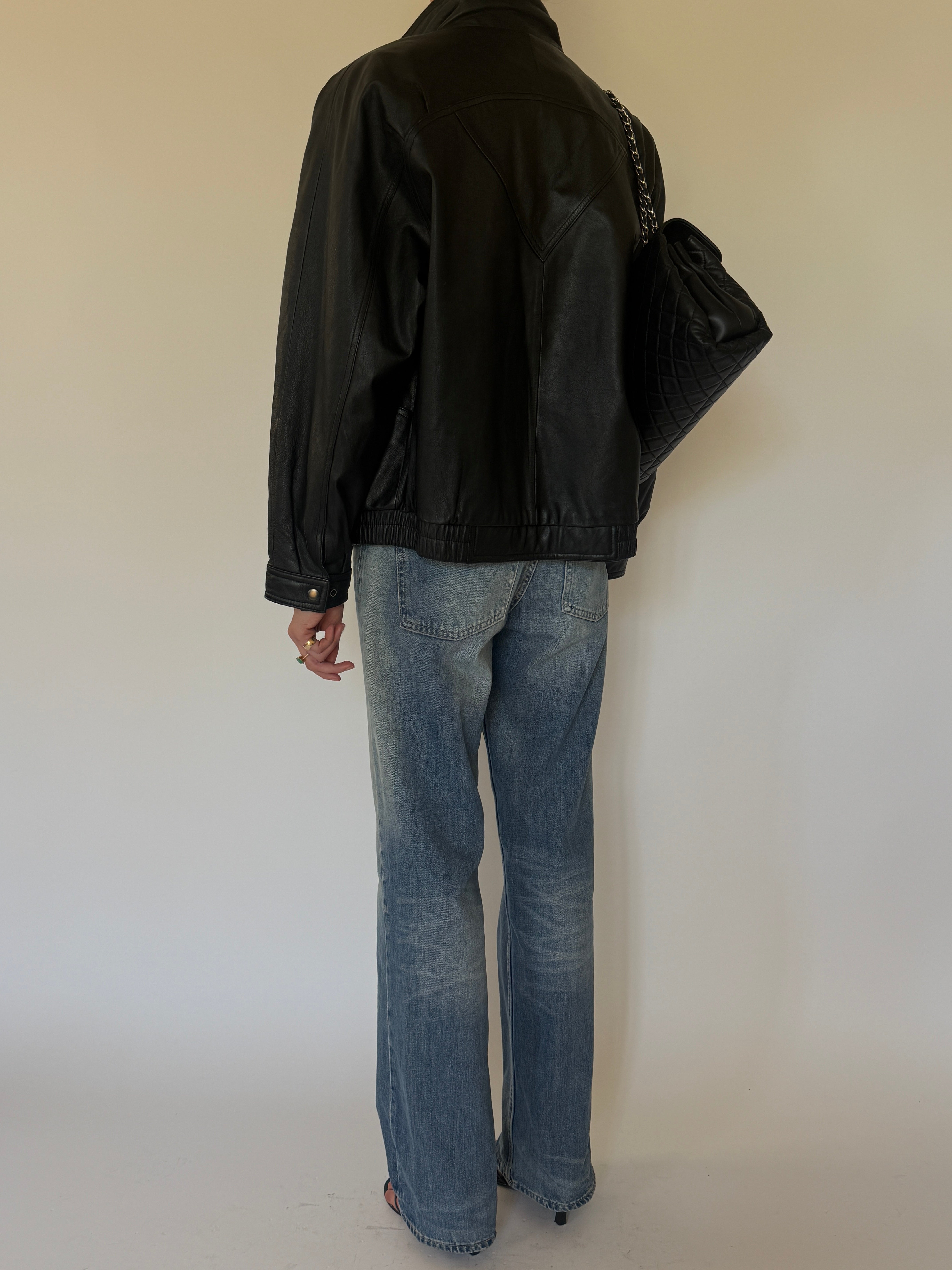 Vintage oversized black leather bomber jacket back view