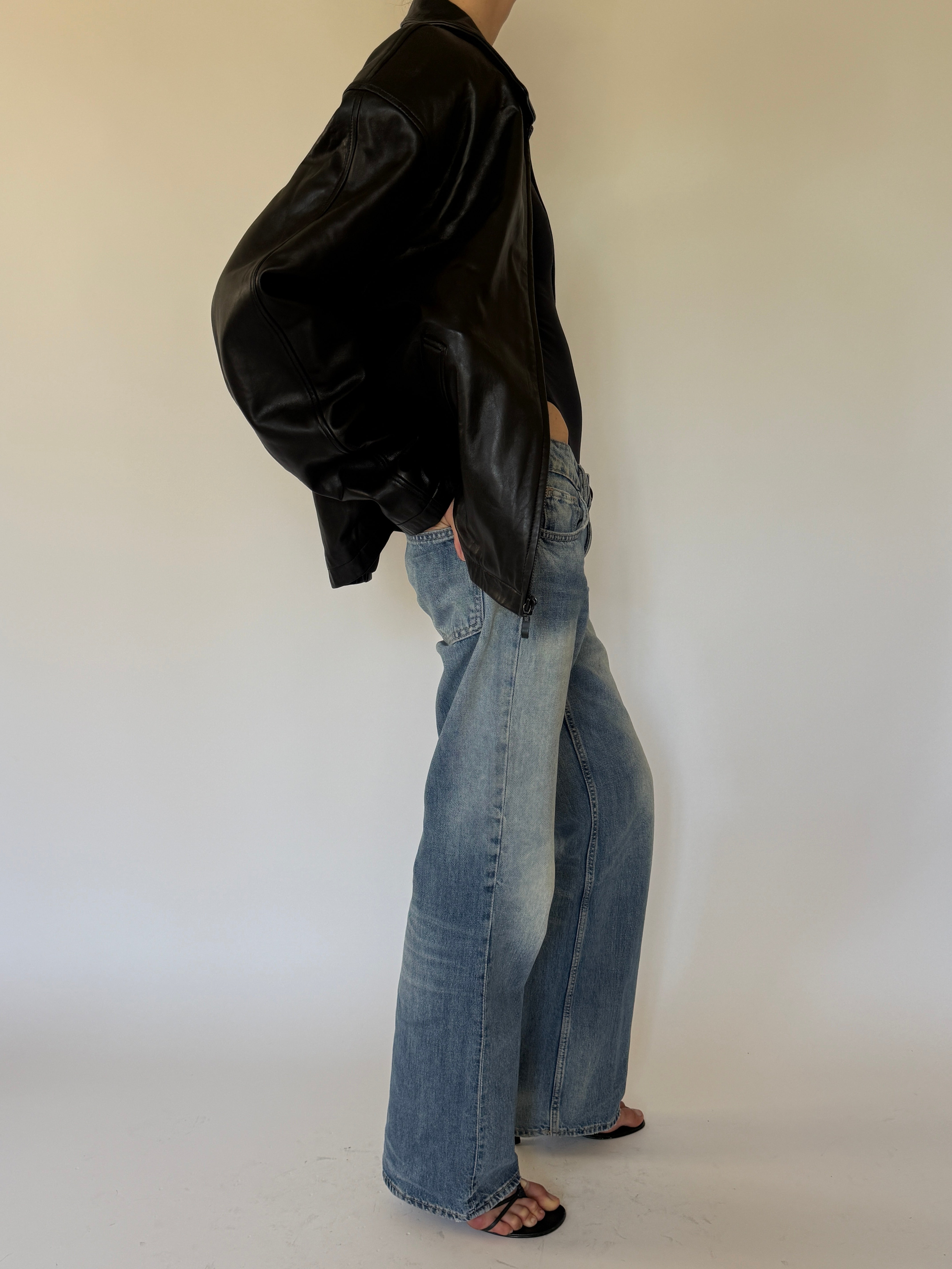 Vintage oversized black leather jacket side view