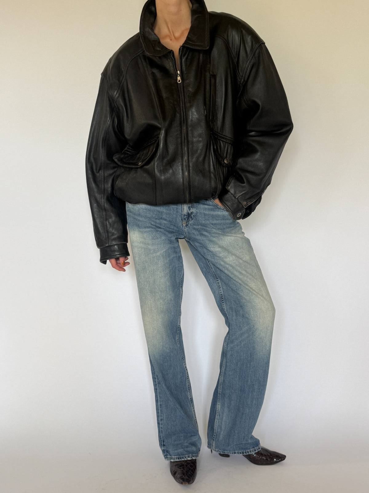 Vintage black leather bomber jacket front zipped view
