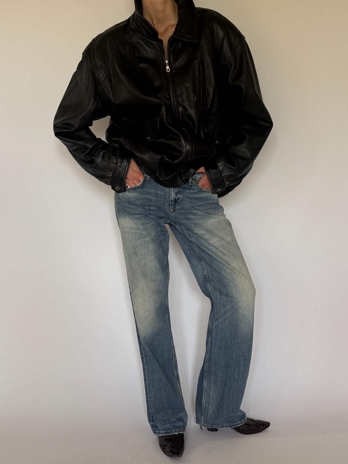 Vintage black leather bomber jacket styled front view
