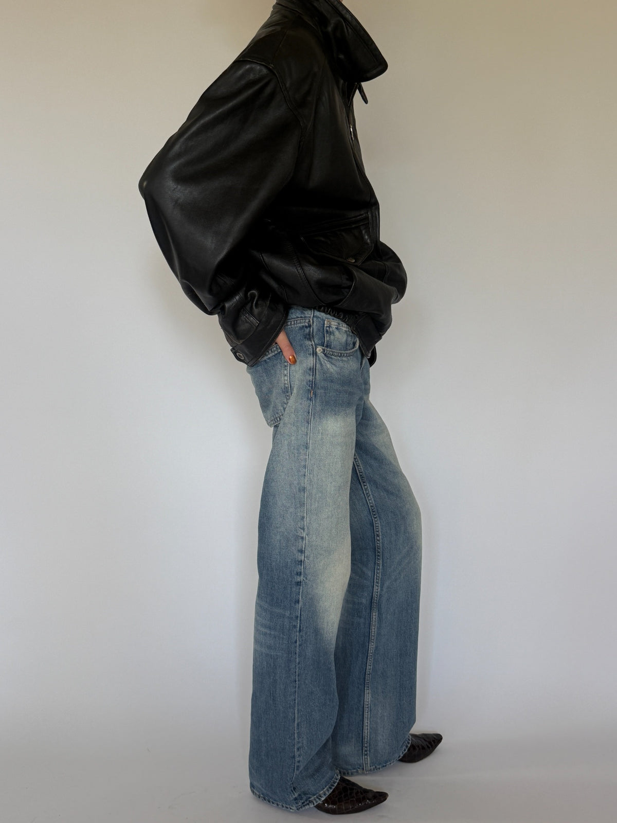 Vintage black leather bomber jacket side profile