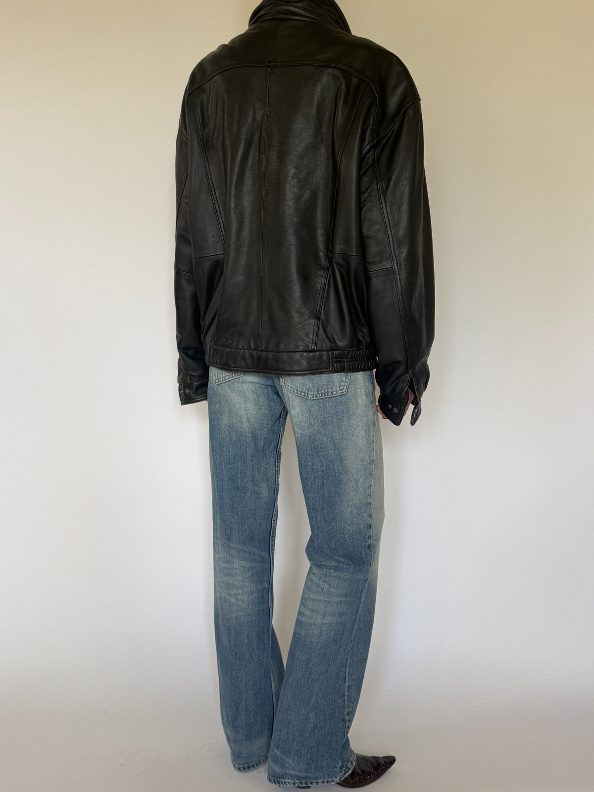 Vintage black leather bomber jacket back view