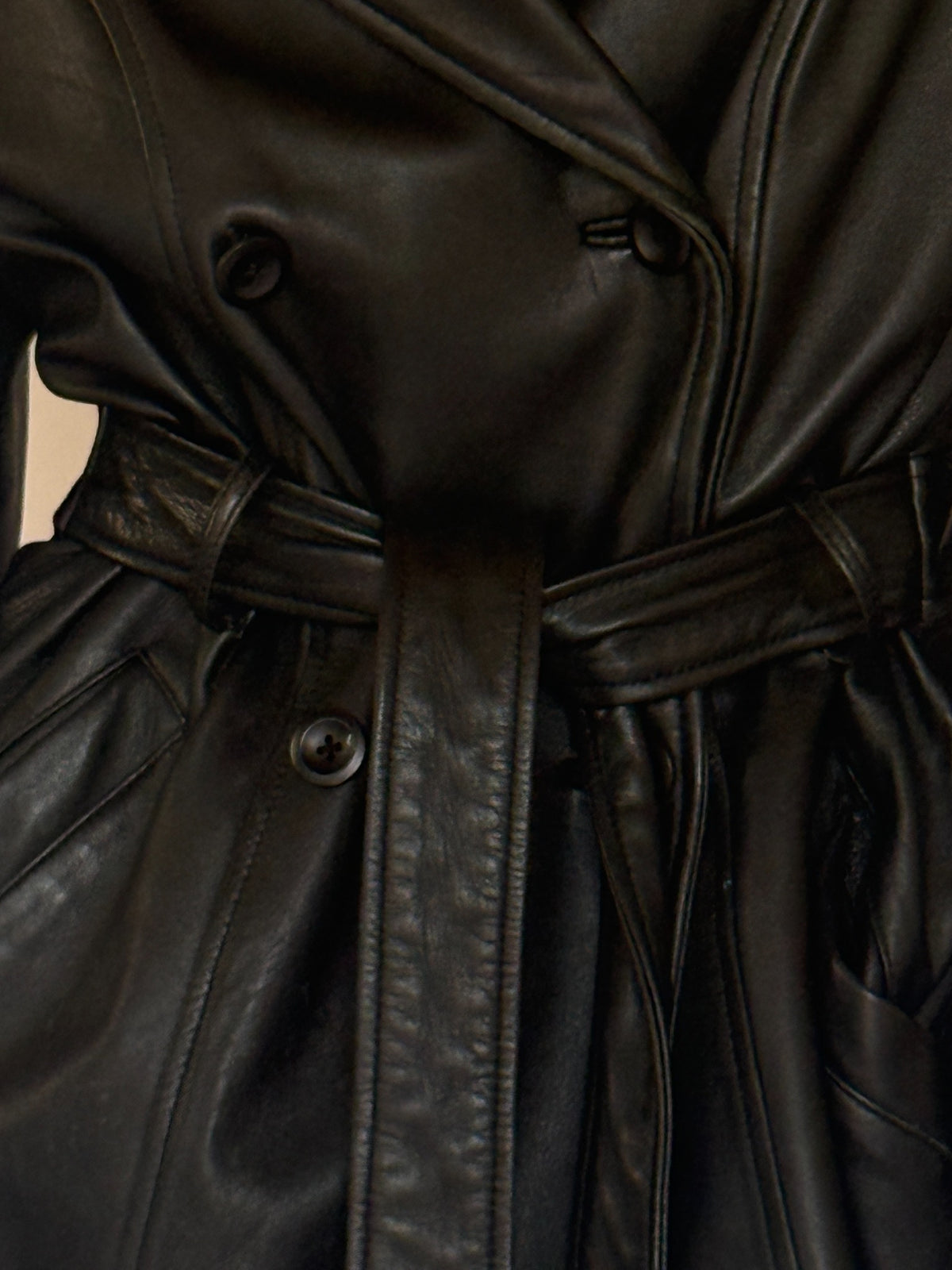 Vintage black leather belted jacket button and belt detail