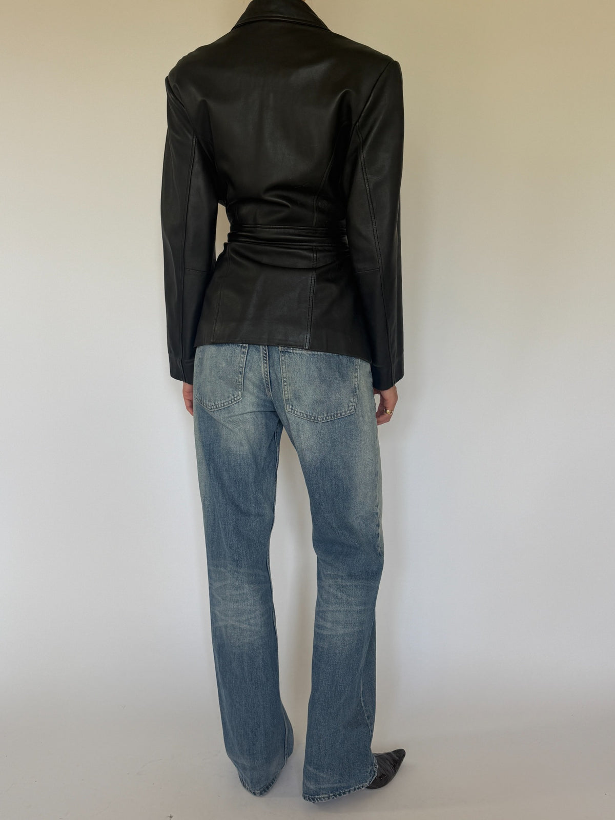 Vintage black leather belted jacket back view