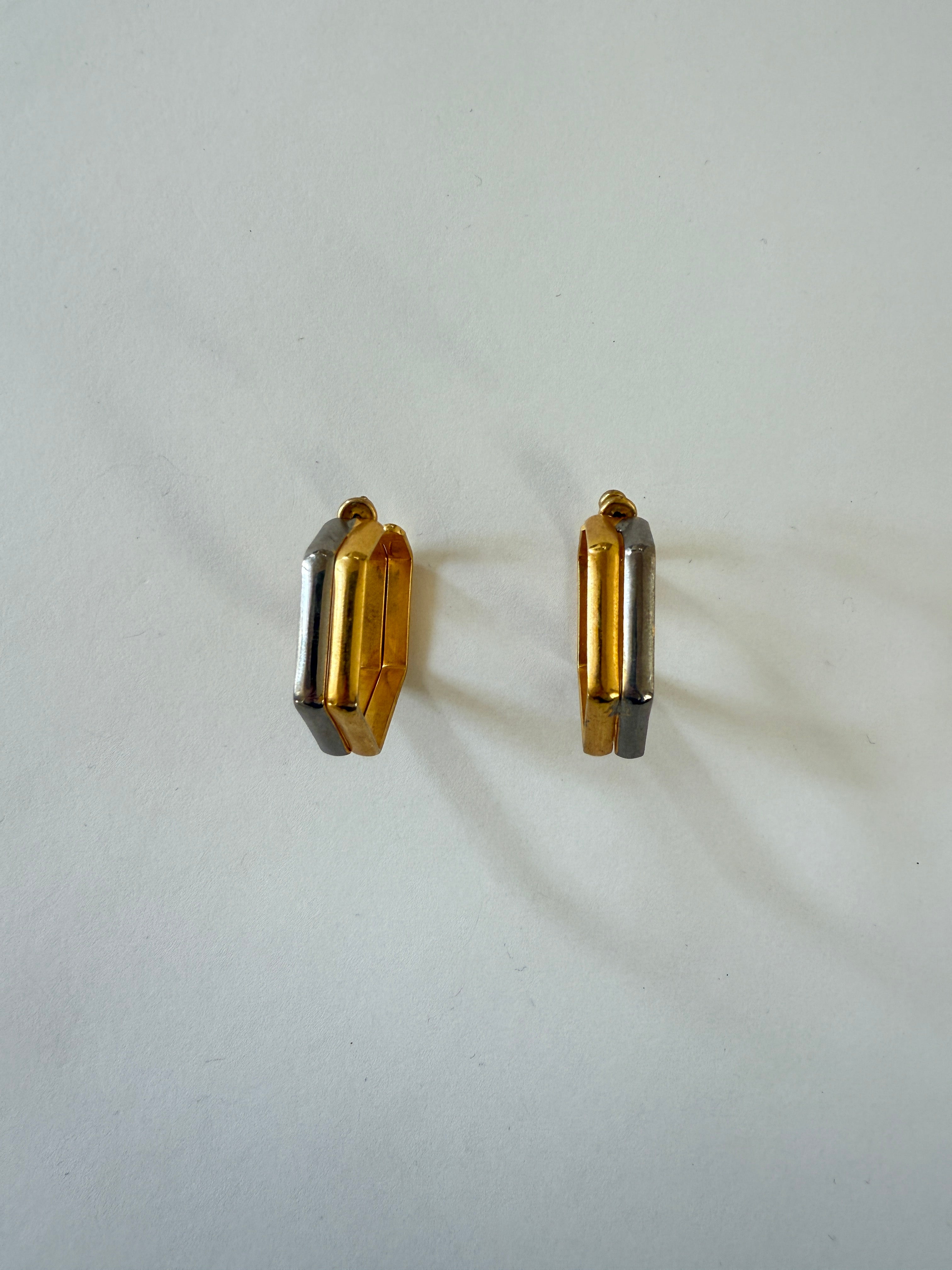 Close-up of vintage gold-tone geometric hoop earring shape