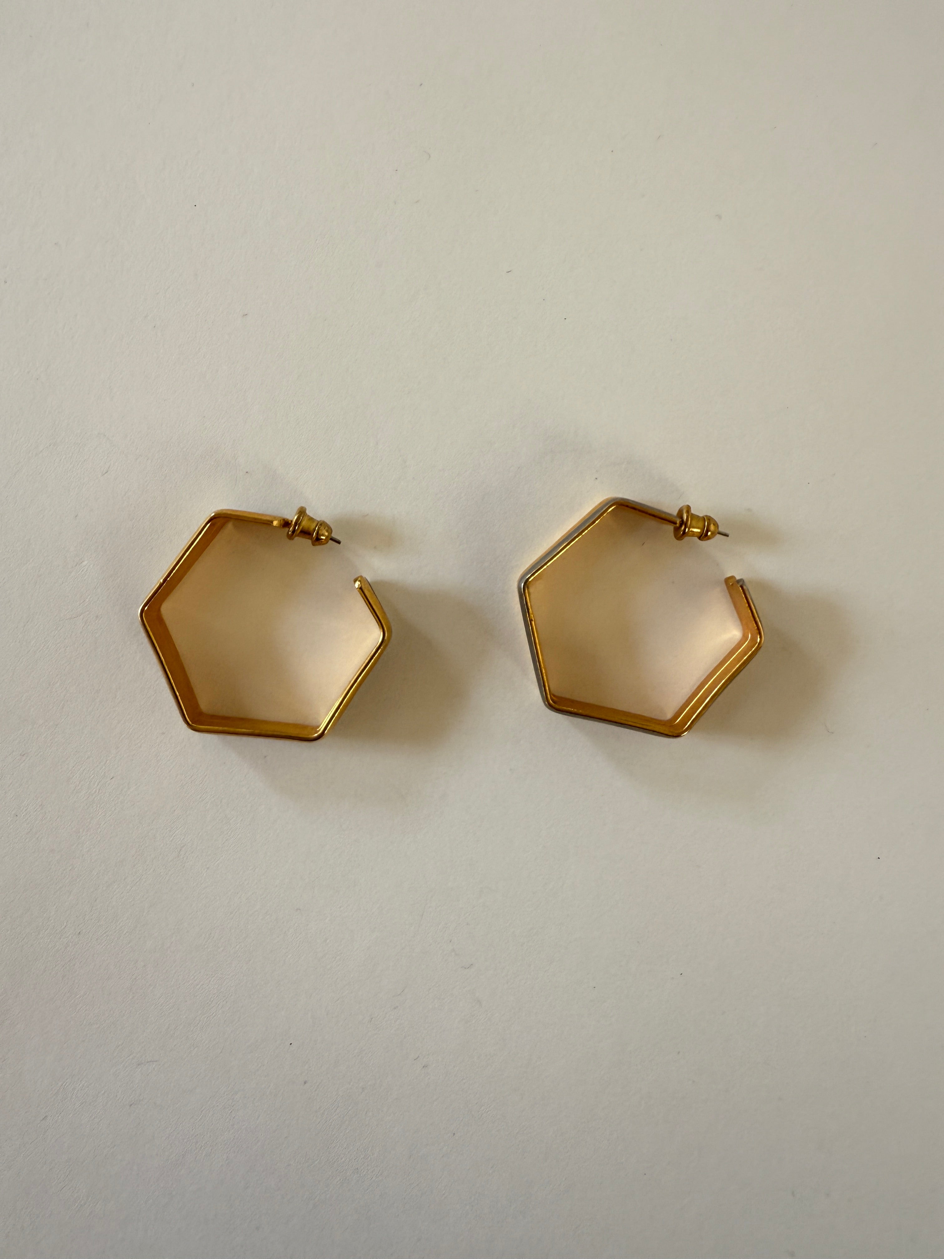 Vintage hexagon-shaped gold-tone hoop earrings laid flat