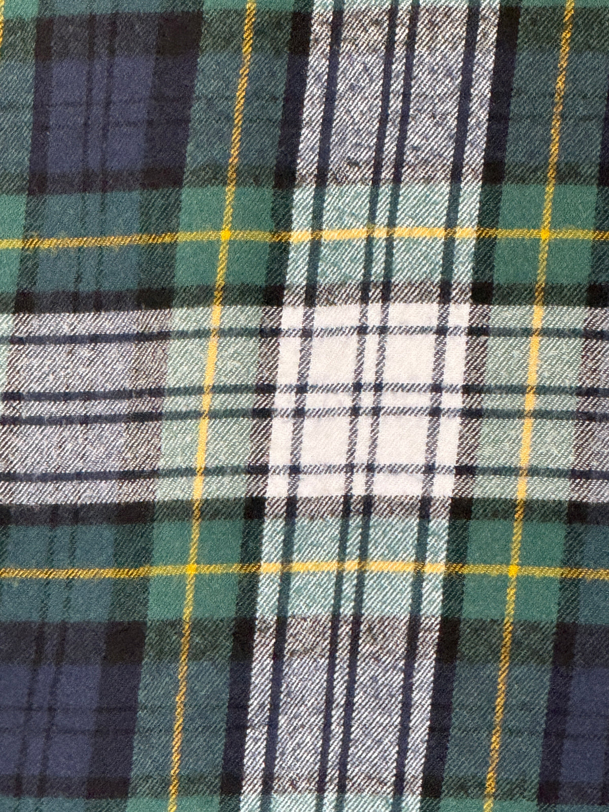 Vintage green navy cream plaid flannel fabric close-up