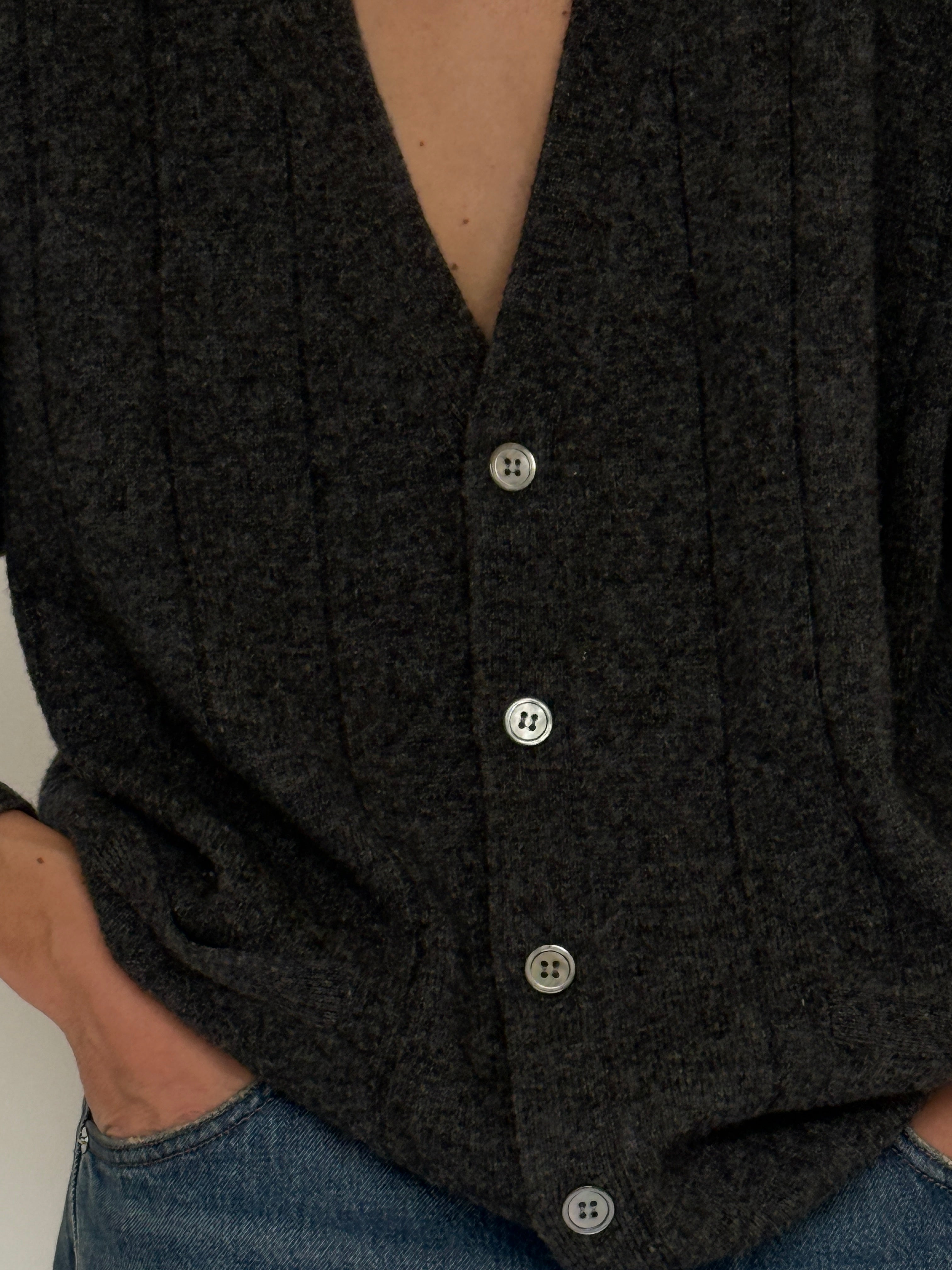 Vintage wool cardigan fabric close-up gray