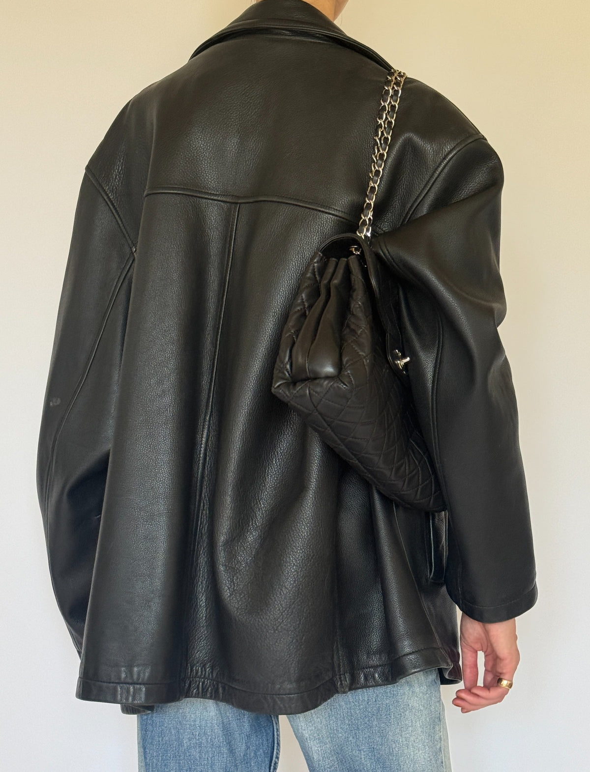 Vintage black leather jacket back seam detail
