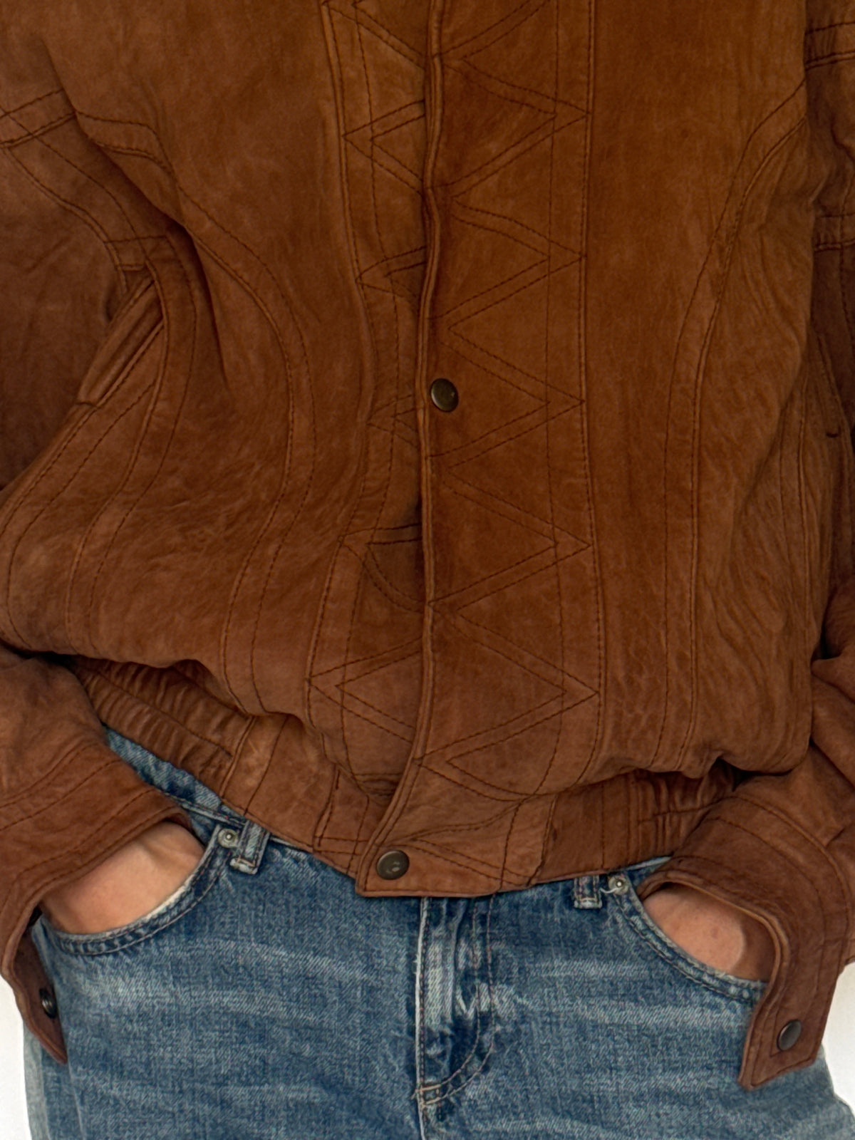 Vintage brown leather bomber jacket geometric topstitching detail
