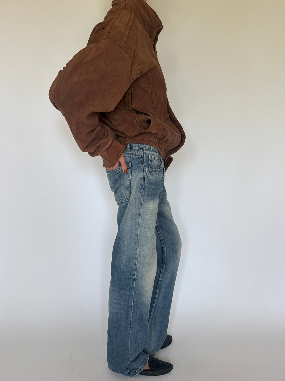Vintage brown leather bomber jacket side view