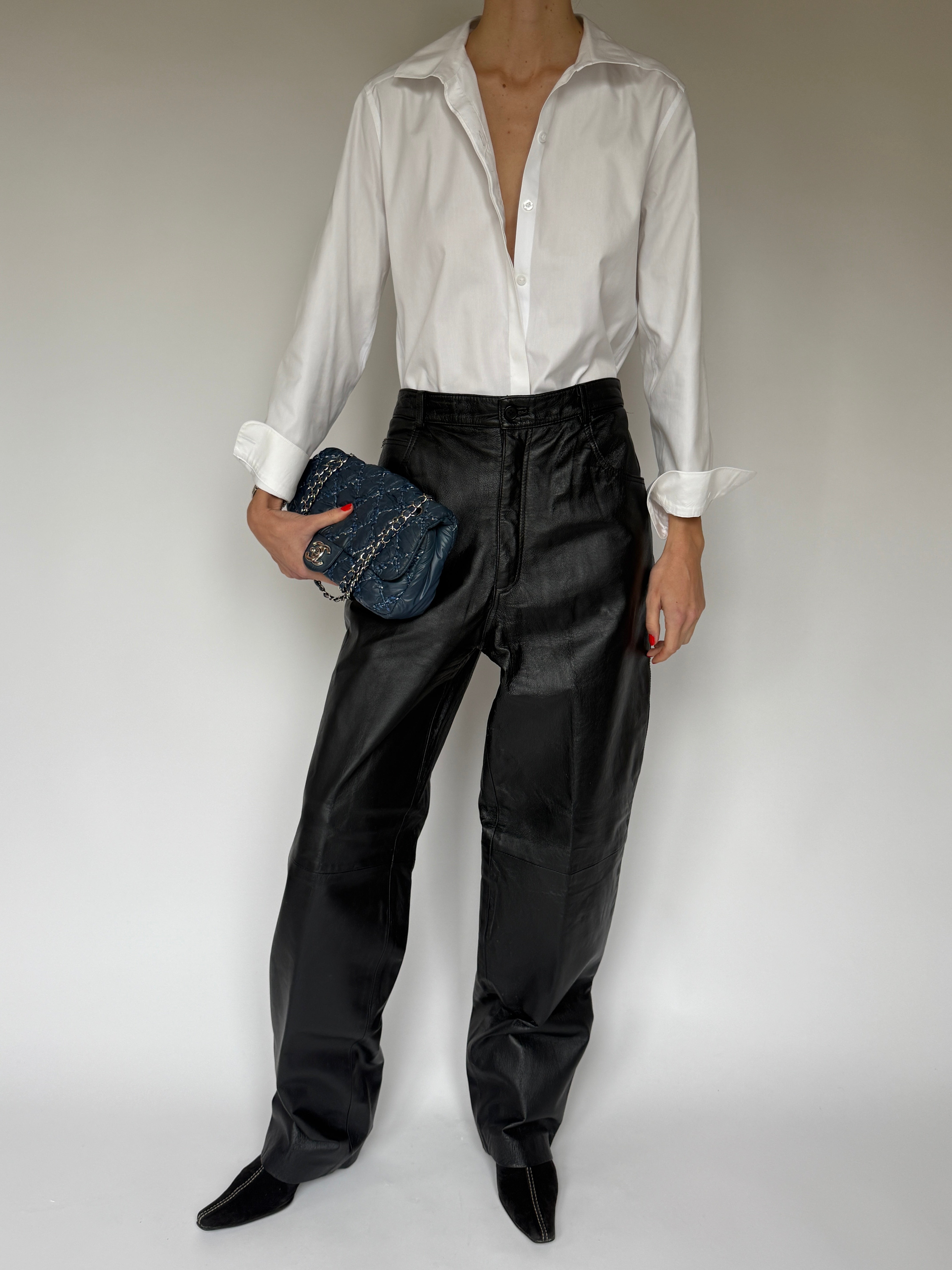 Vintage black straight-leg leather pants front view styled