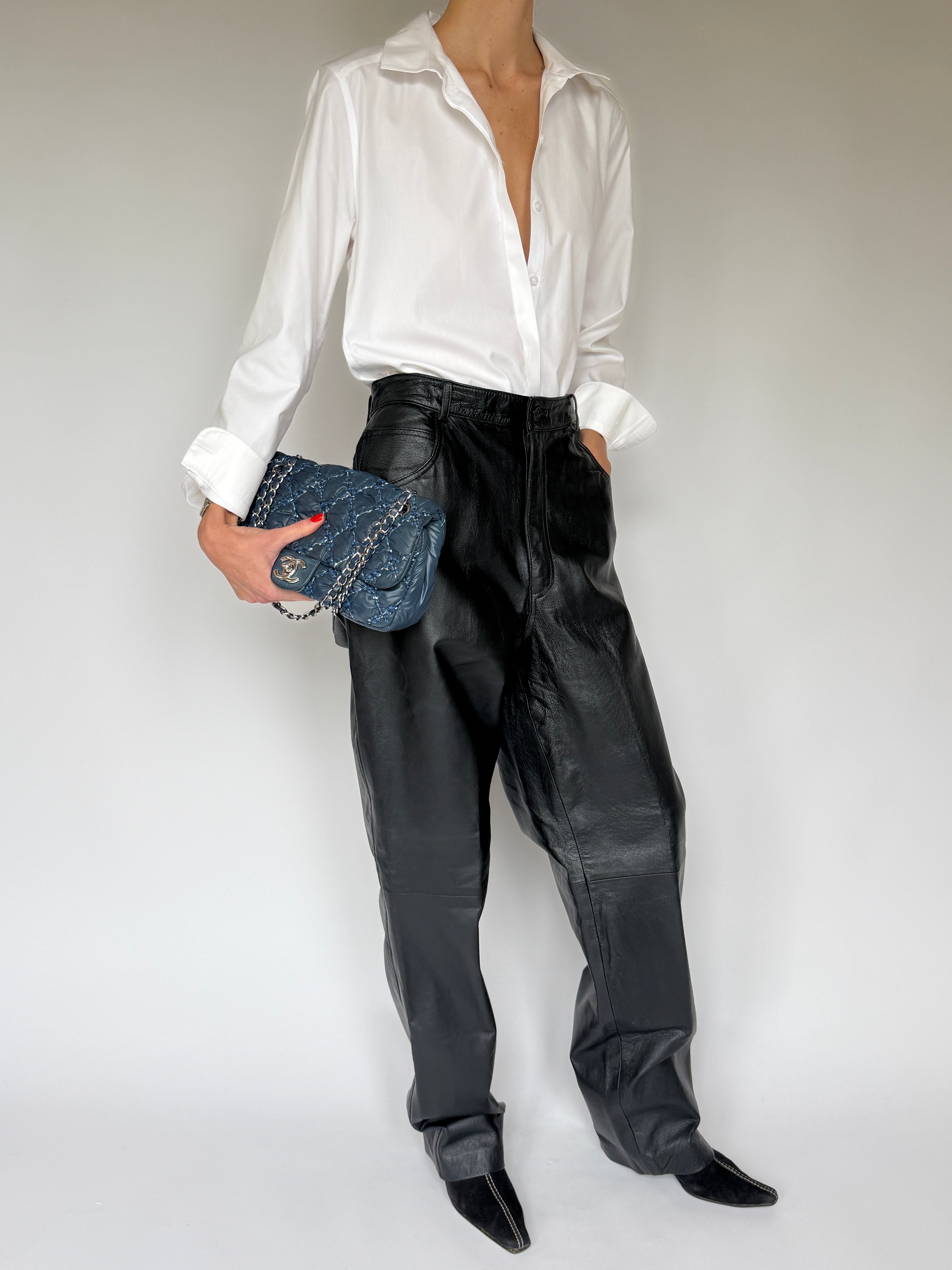 Side view of vintage black leather straight-leg pants
