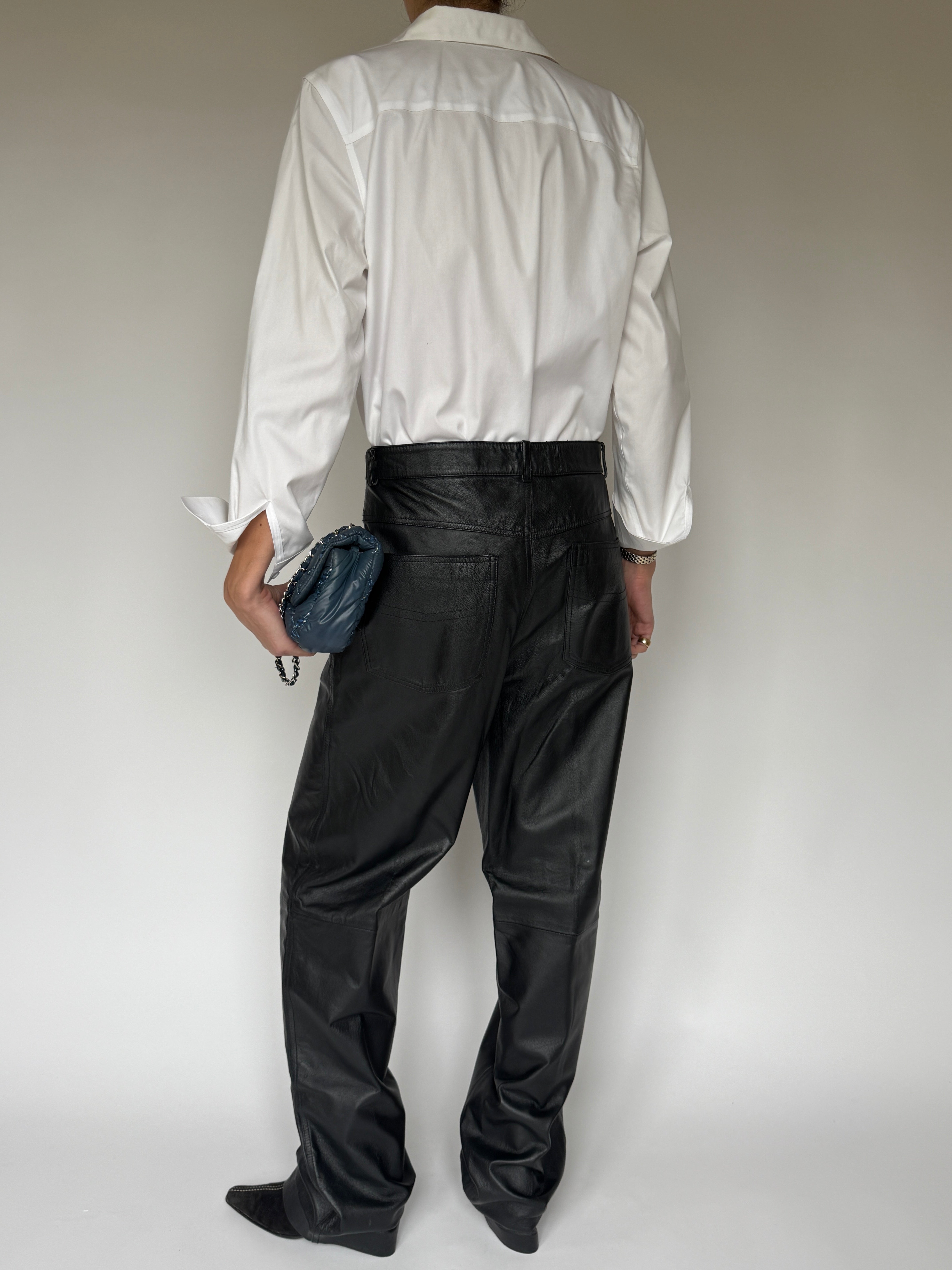 Back view of vintage black straight-leg leather pants