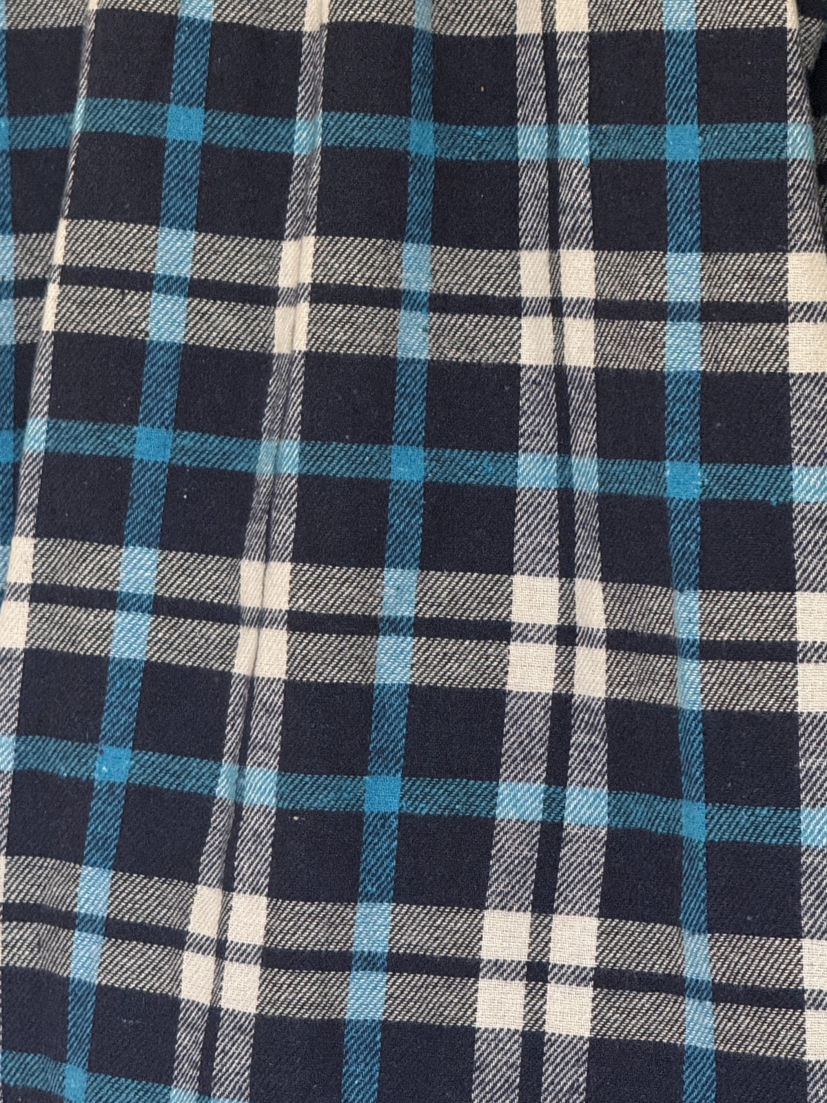 Vintage plaid flannel shirt navy blue cream plaid fabric close-up