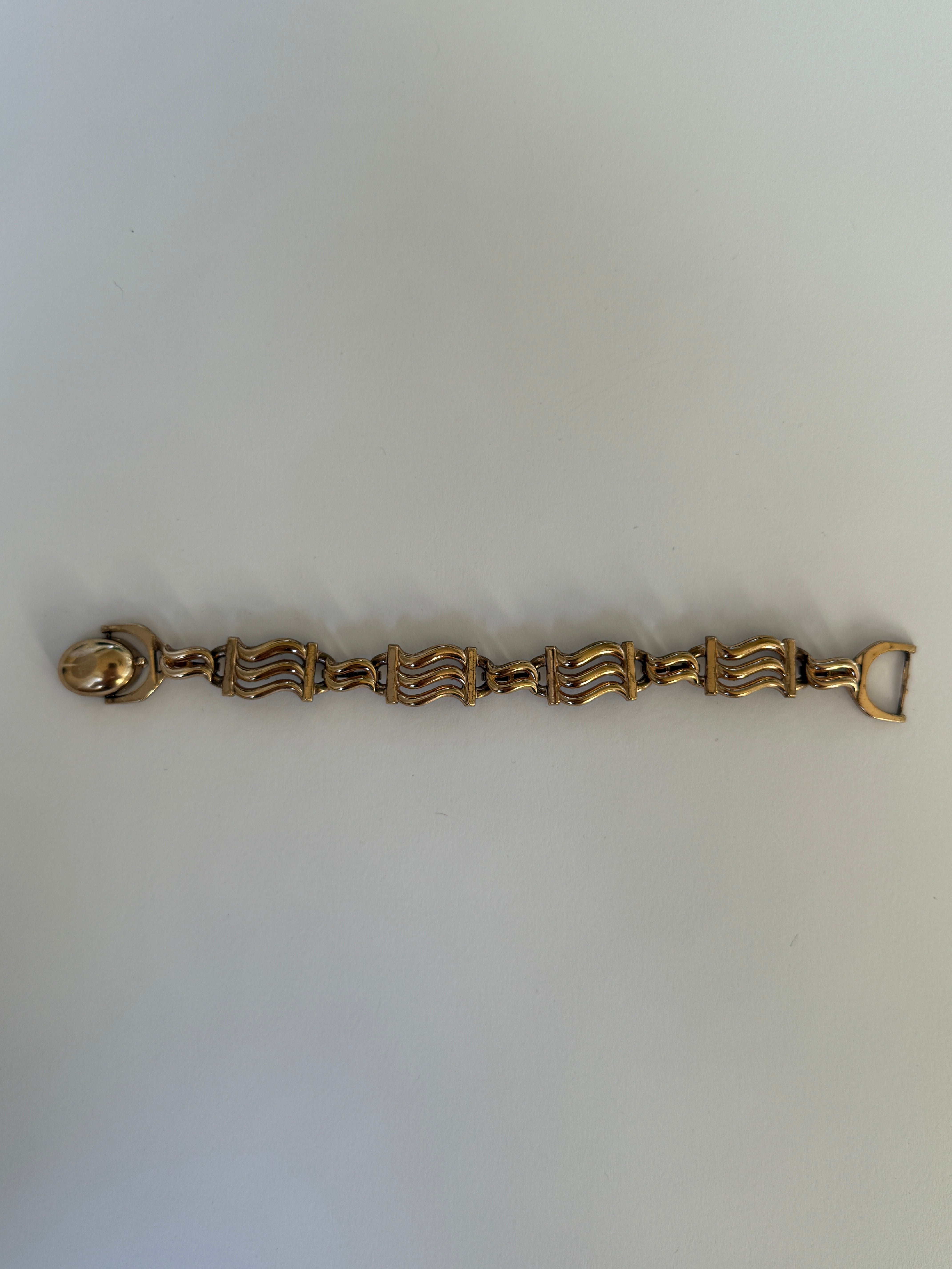 Vintage gold-tone statement bracelet flat lay