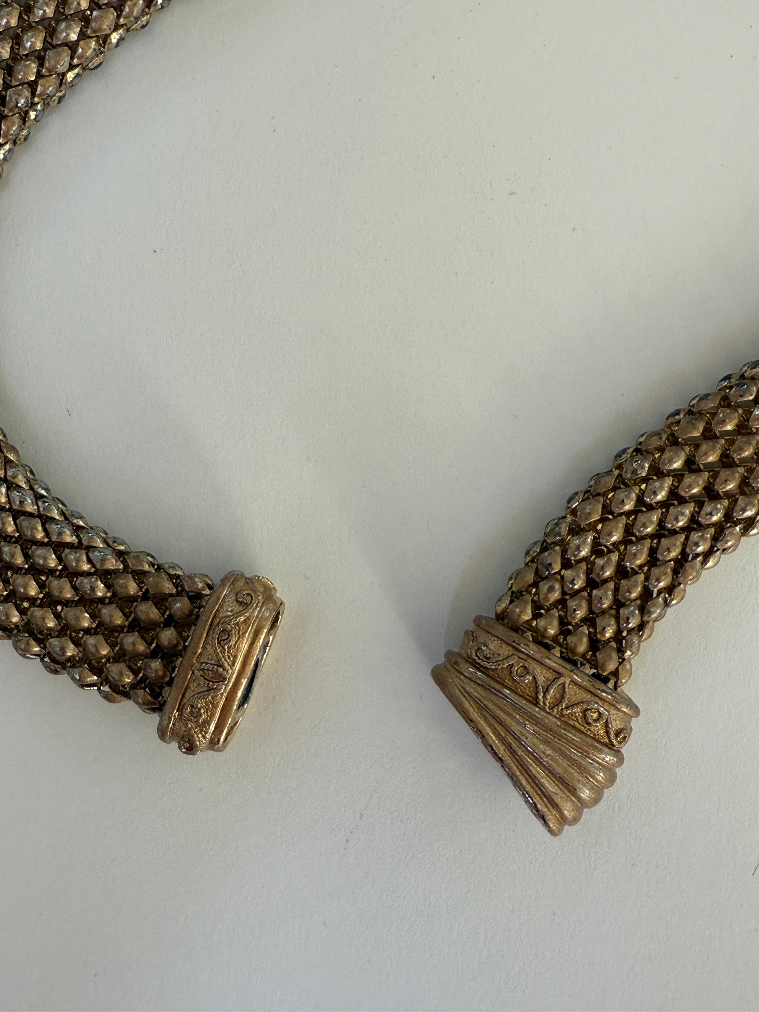 Vintage gold-tone mesh necklace texture close-up