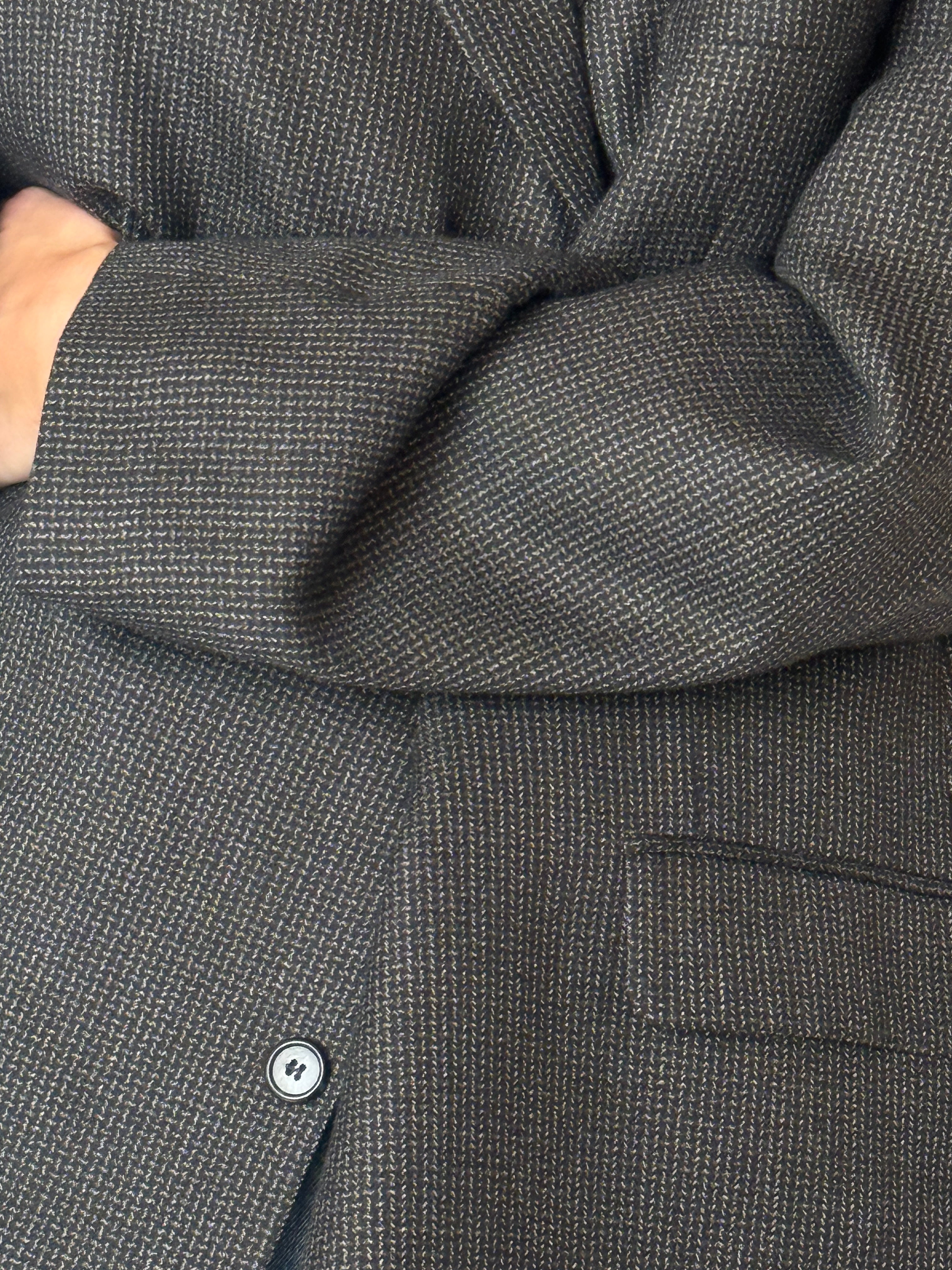 Close-up of vintage charcoal wool blend blazer fabric texture