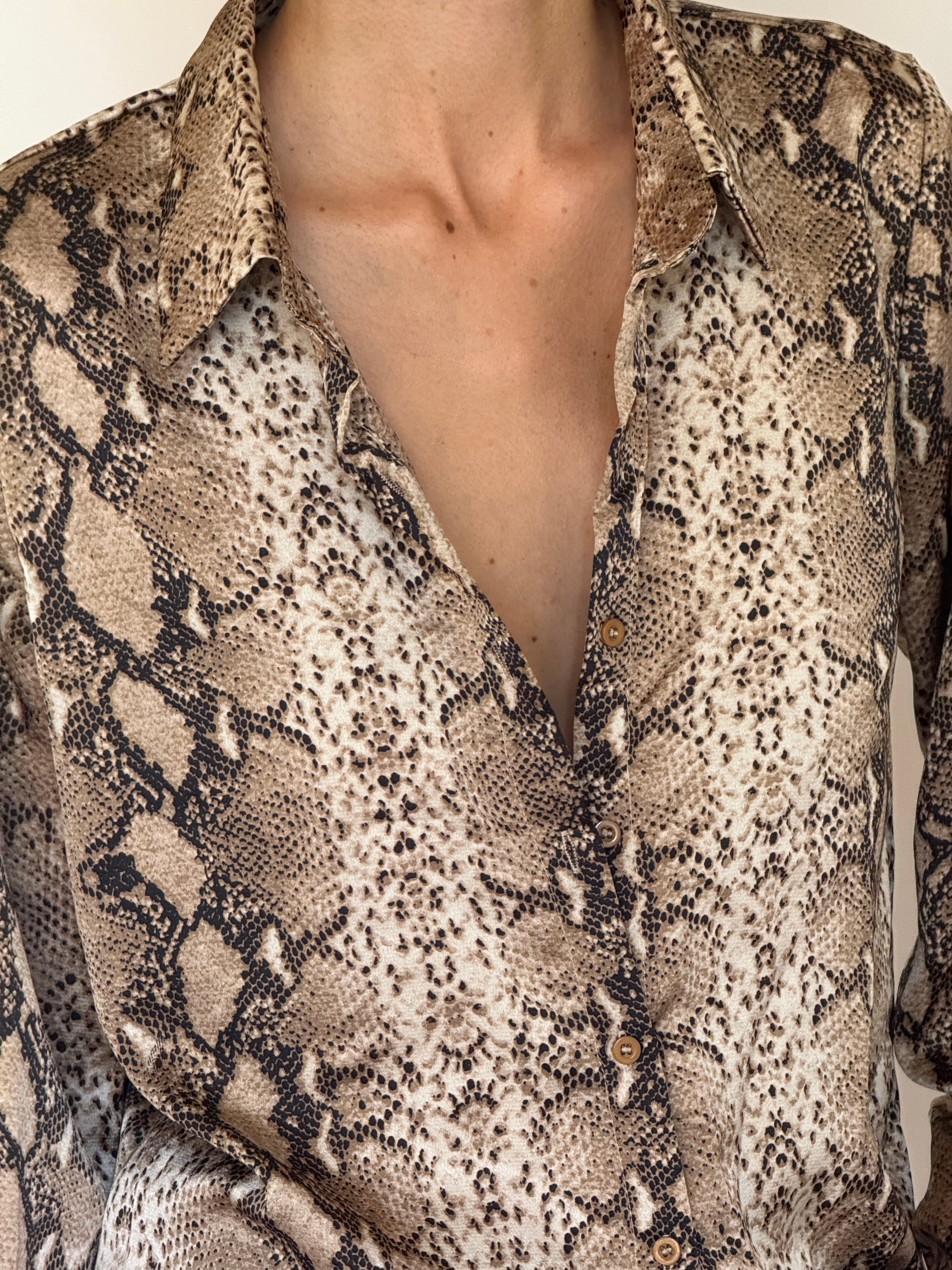 Vintage snake print button-up shirt fabric close-up