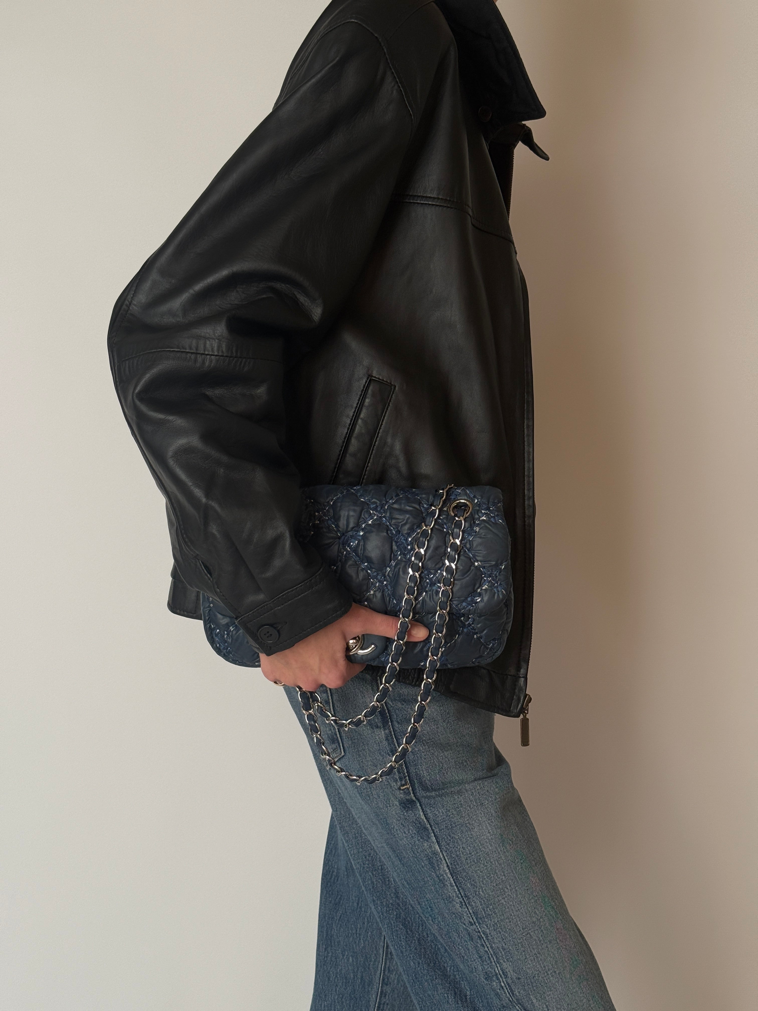 Vintage black leather zip jacket with pointed collar and elasticated hem side view