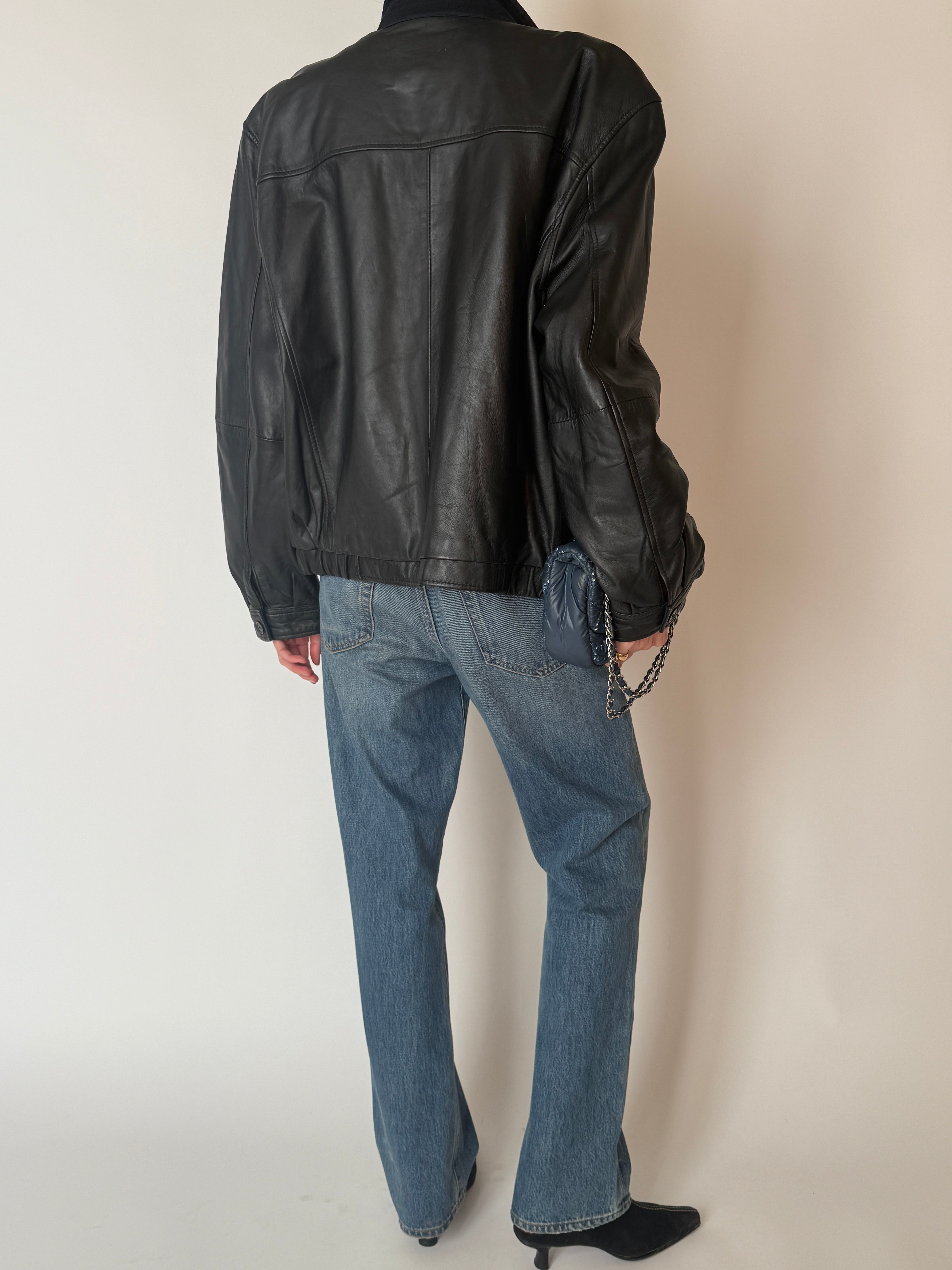 Vintage black leather zip jacket with pointed collar and elasticated hem back view