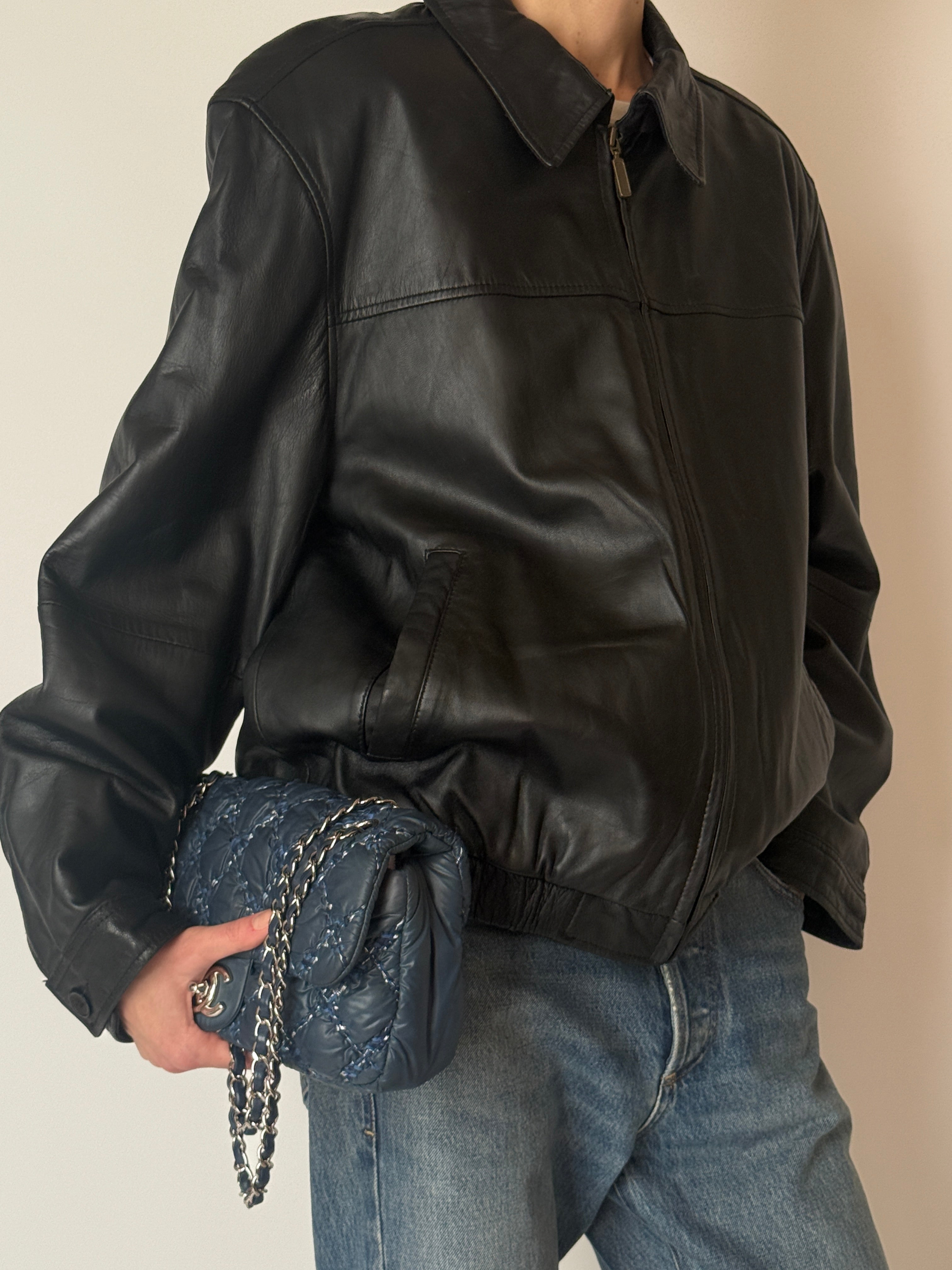 Vintage black leather jacket featuring a relaxed blouson silhouette