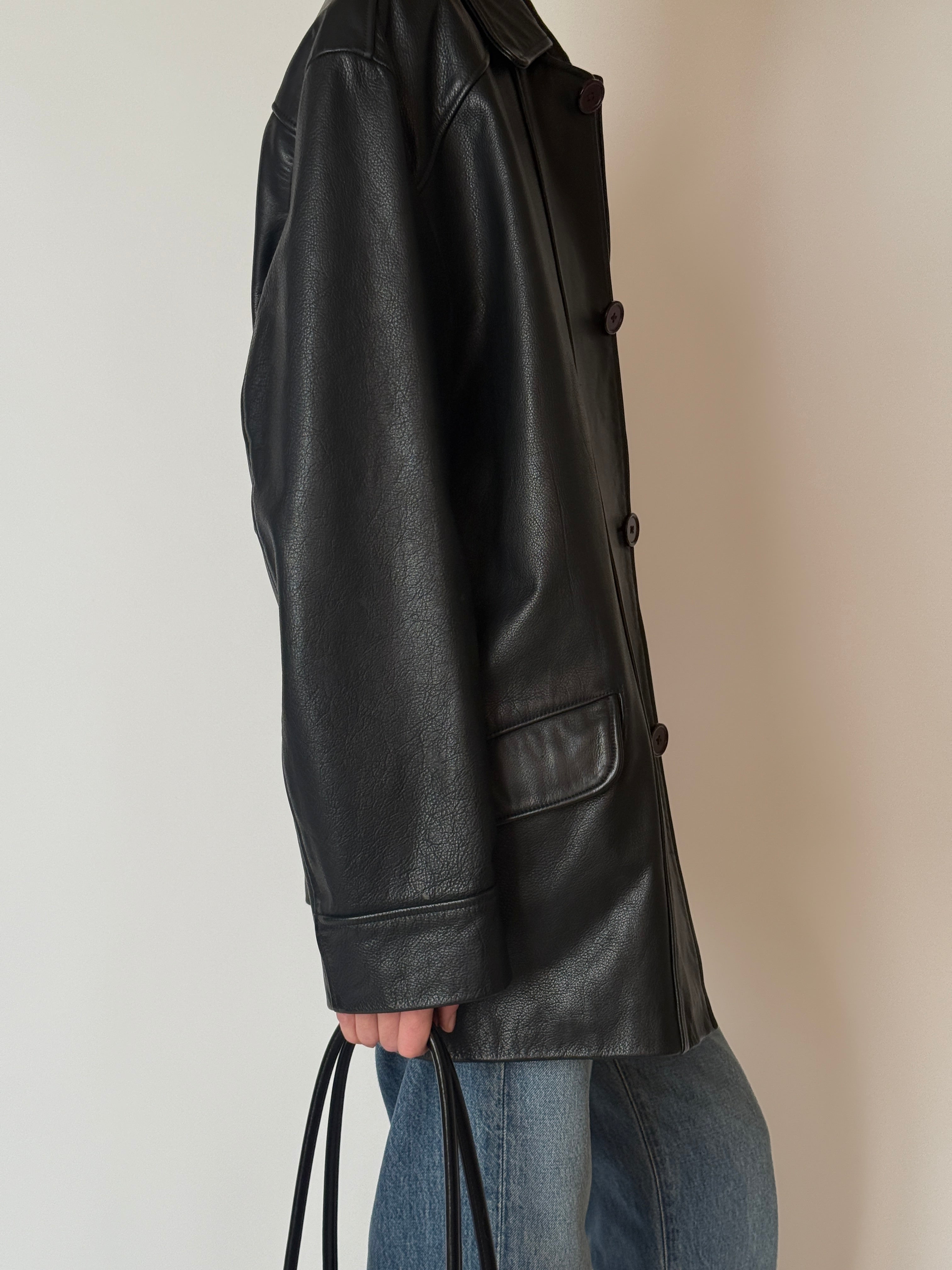 Vintage black leather jacket with soft patina and front pockets side view