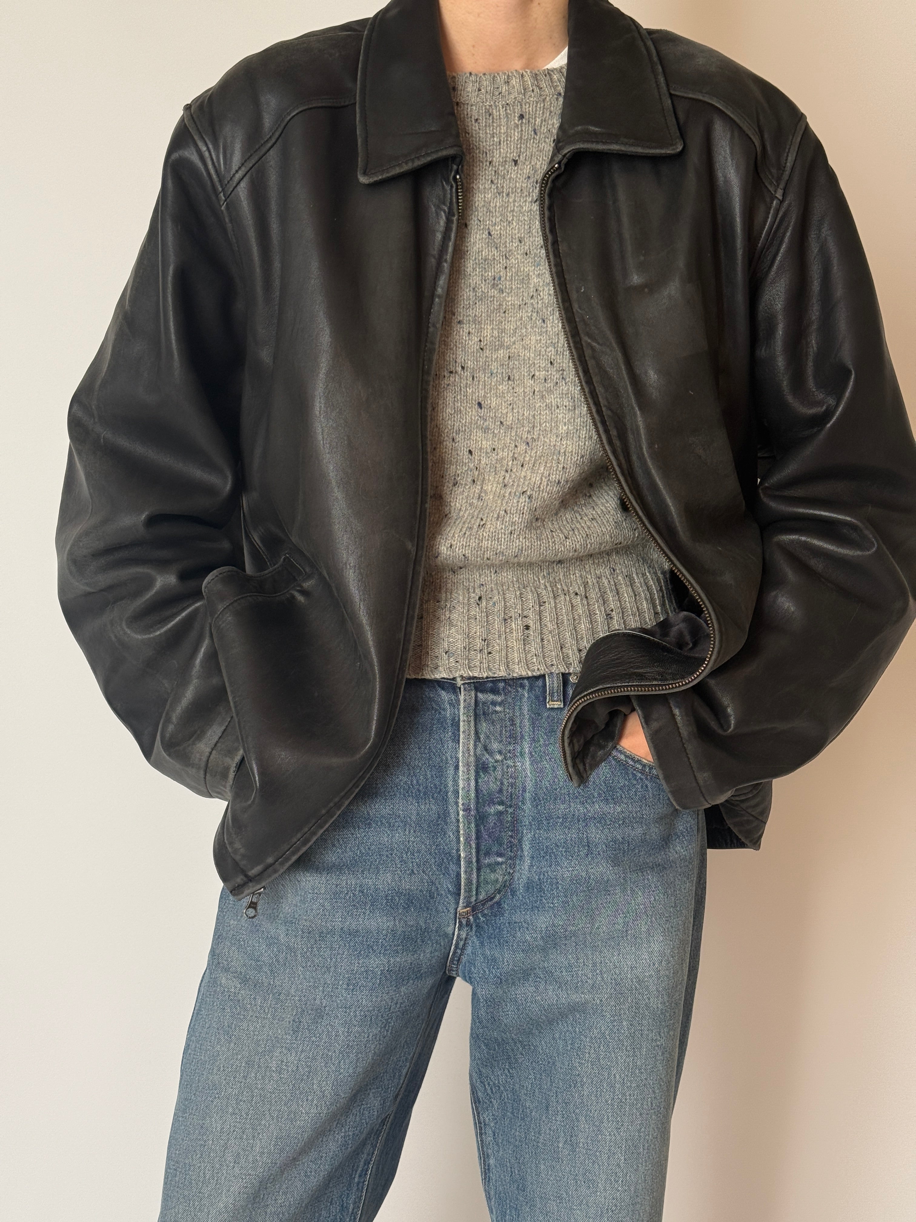 Black vintage leather jacket with zip-front closure