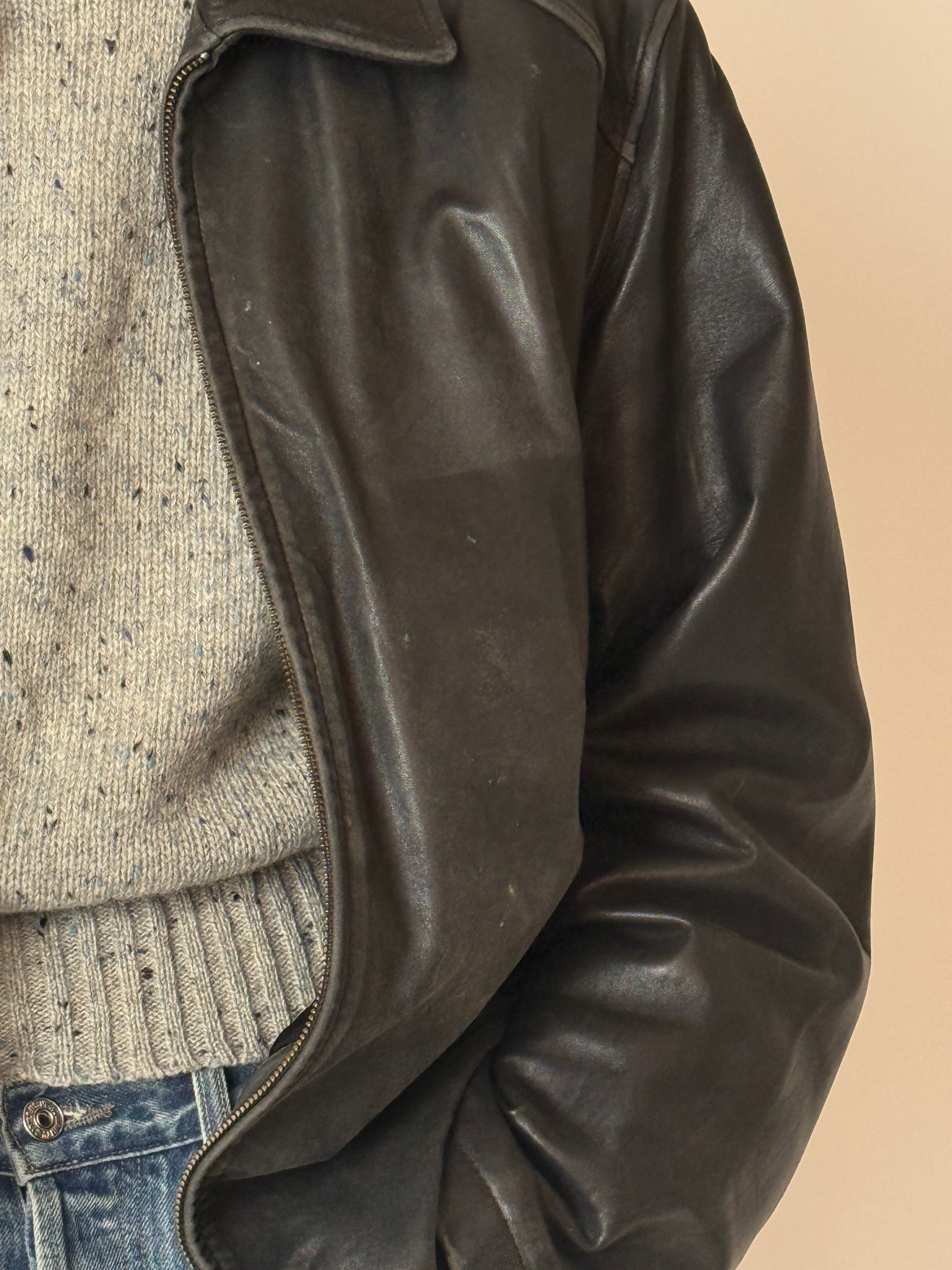 Black vintage leather jacket with zip-front closure