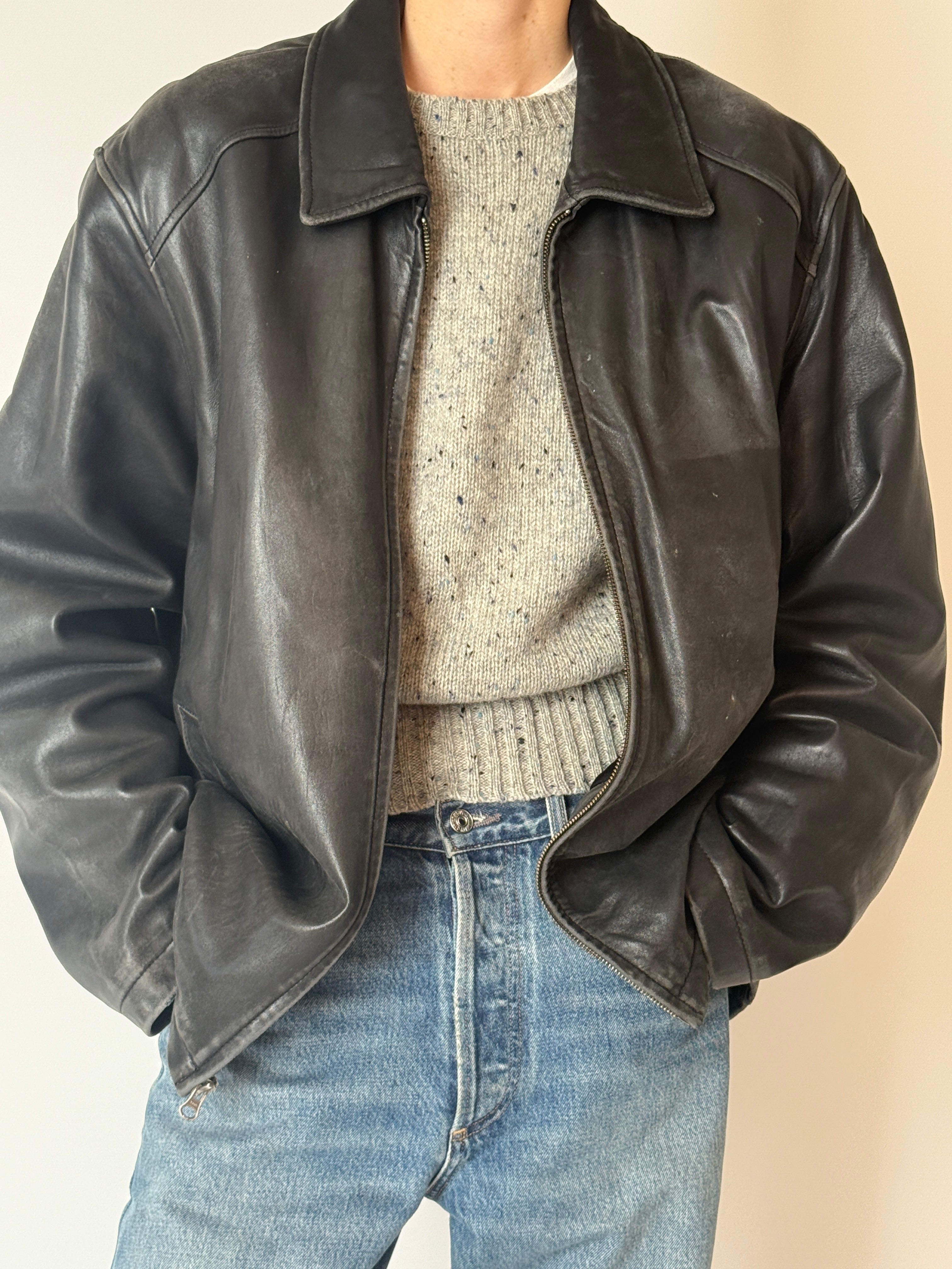 Black vintage leather jacket with zip-front closure