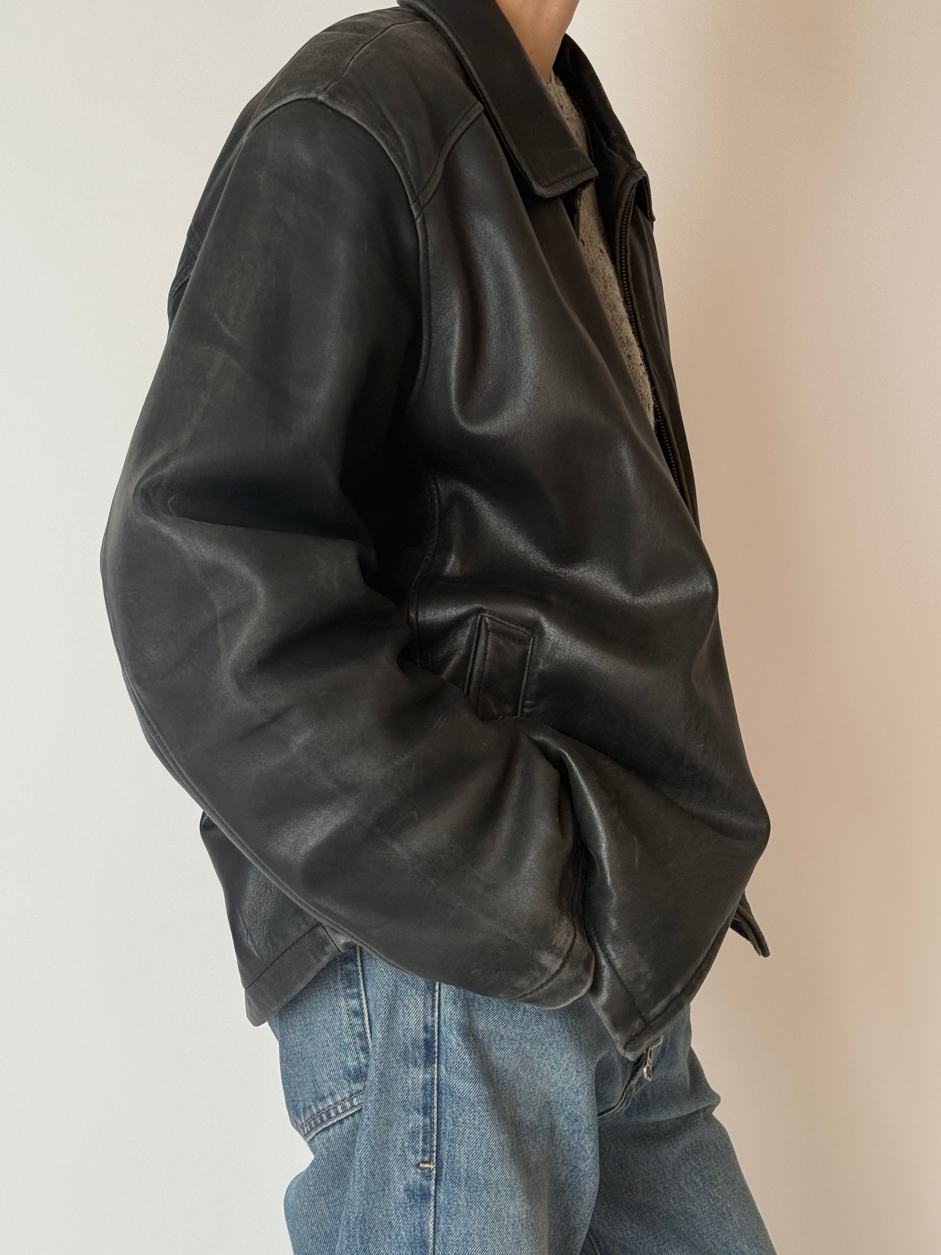 Vintage leather jacket with relaxed fit and natural wear side view