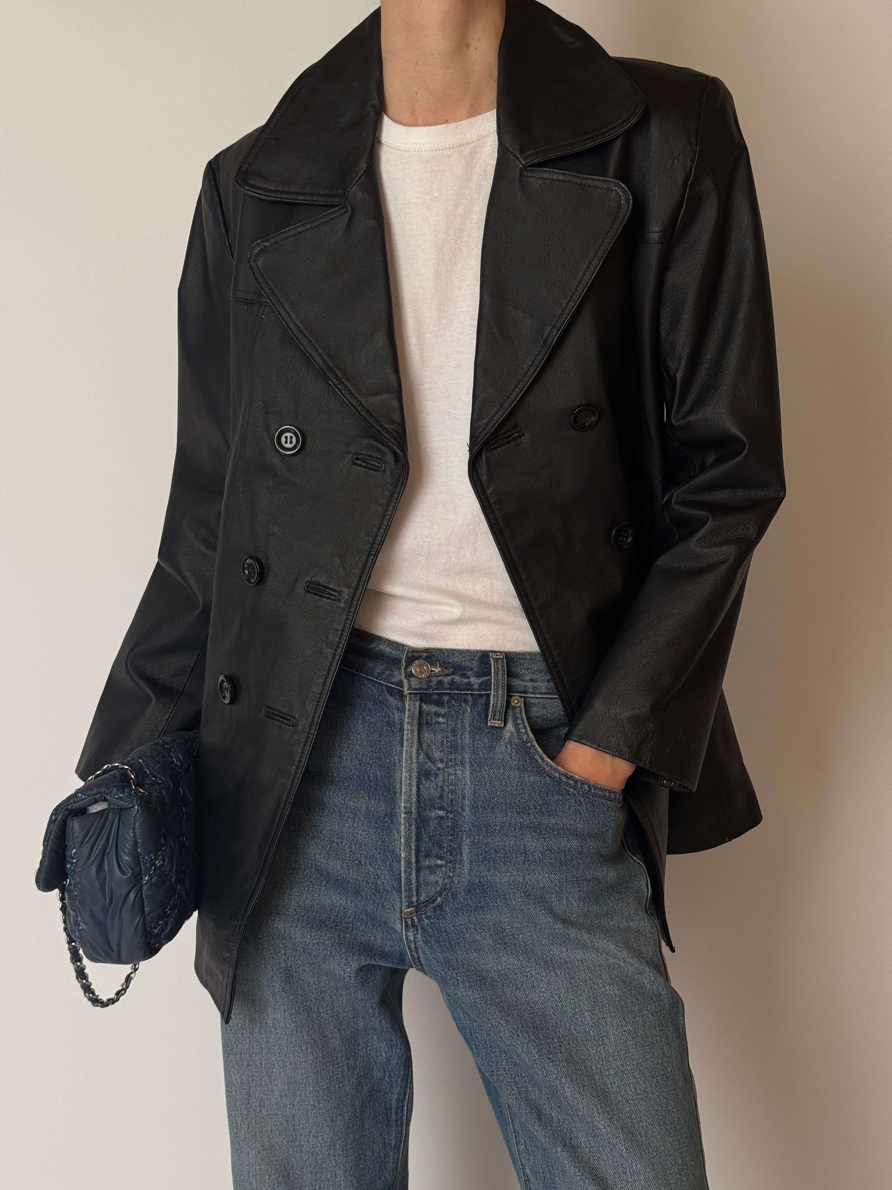 Vintage leather jacket with notched lapels and button-front closure in black