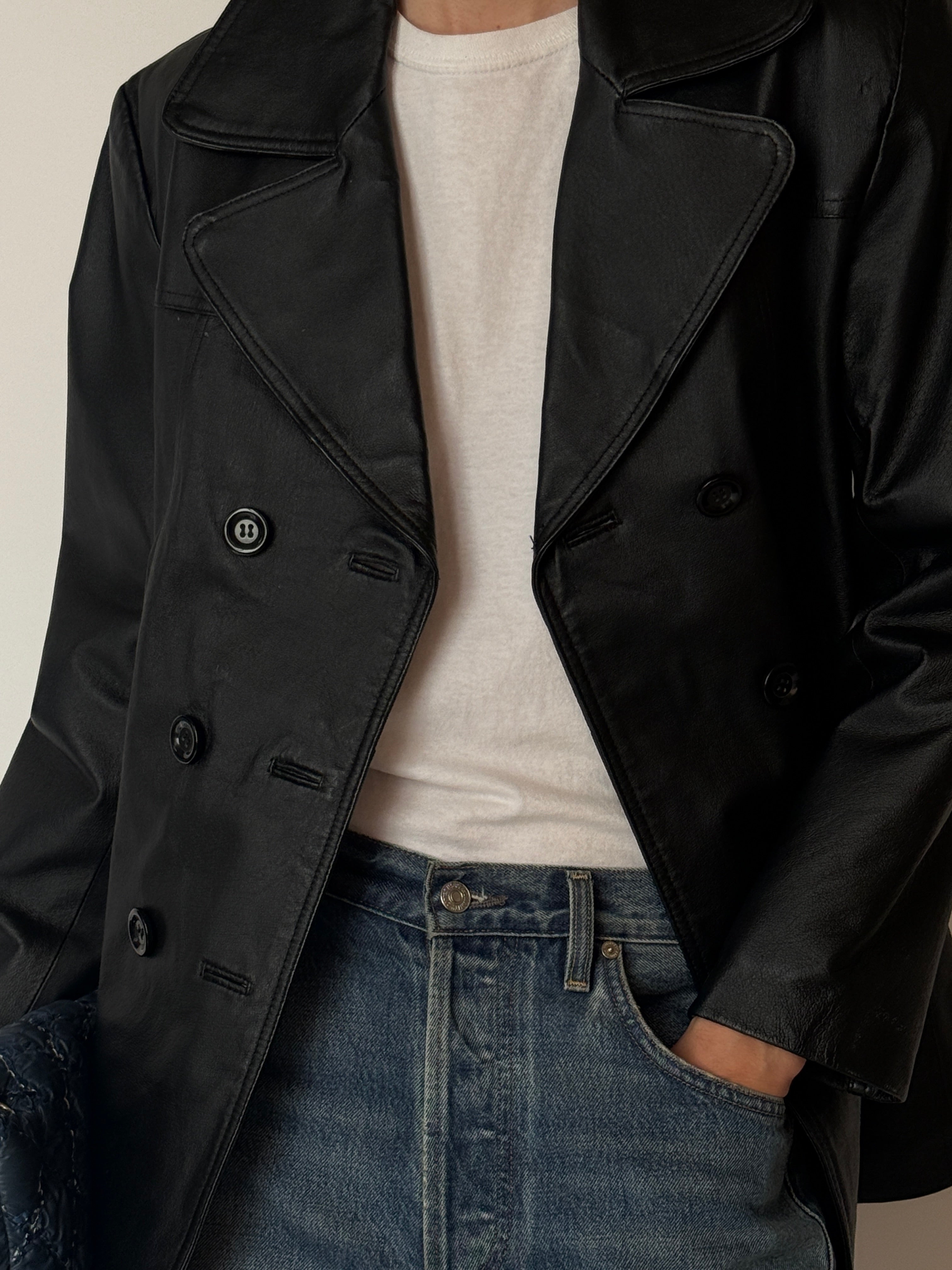 Vintage leather jacket with notched lapels and button-front closure in black detail