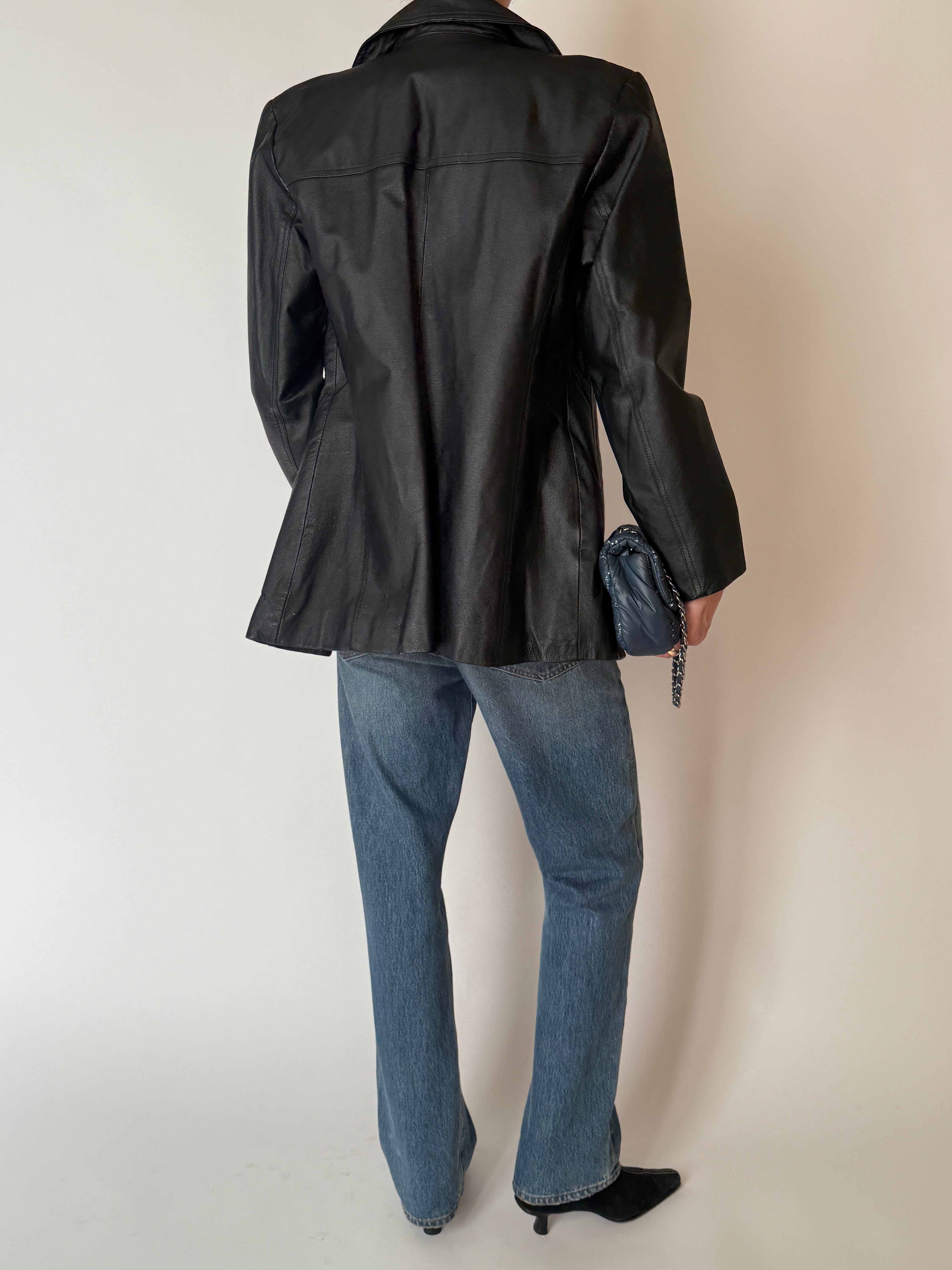 Vintage leather jacket with notched lapels and button-front closure in black back view