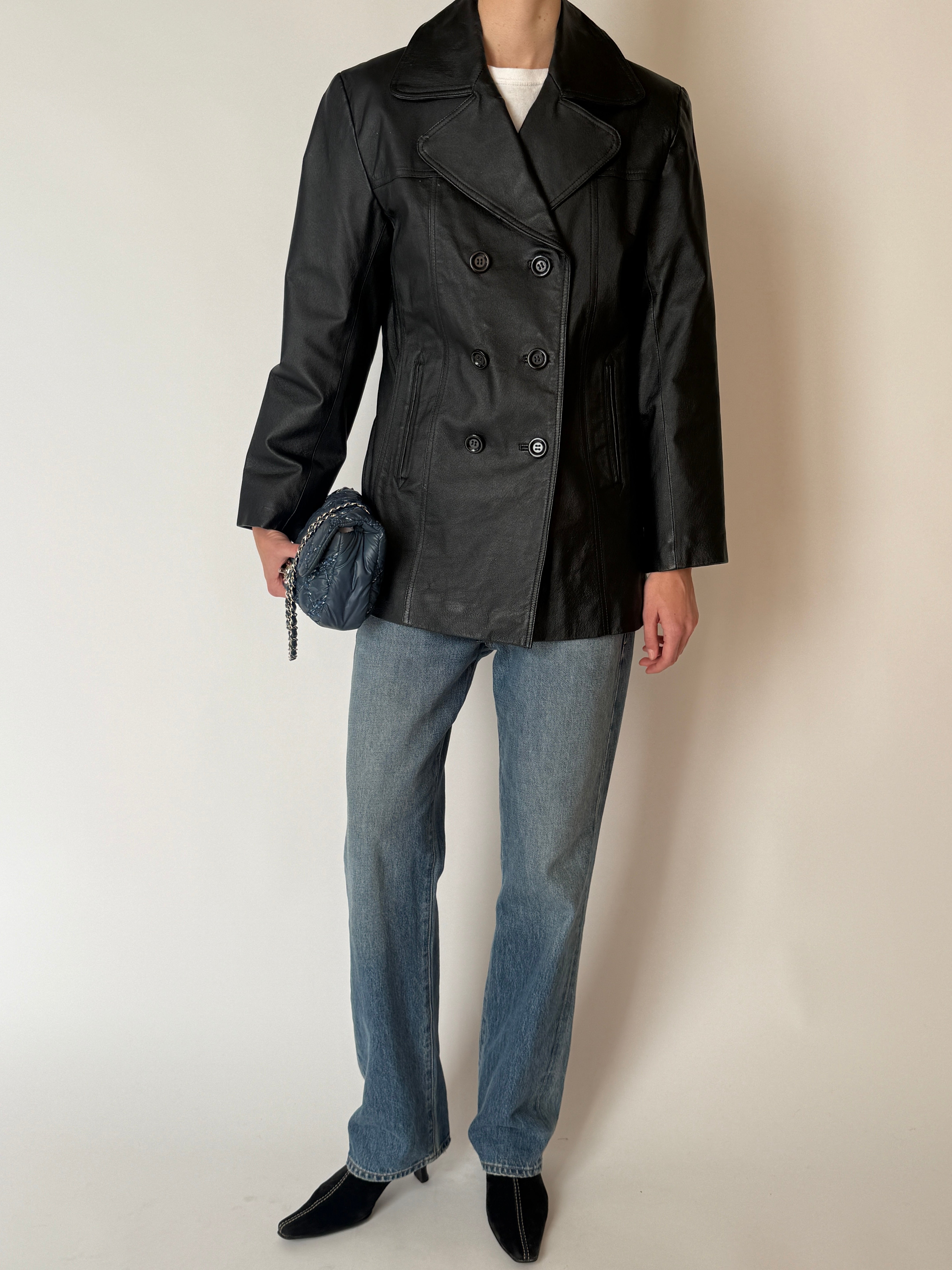 Vintage leather double-breasted jacket with wide lapels and structured silhouette in black