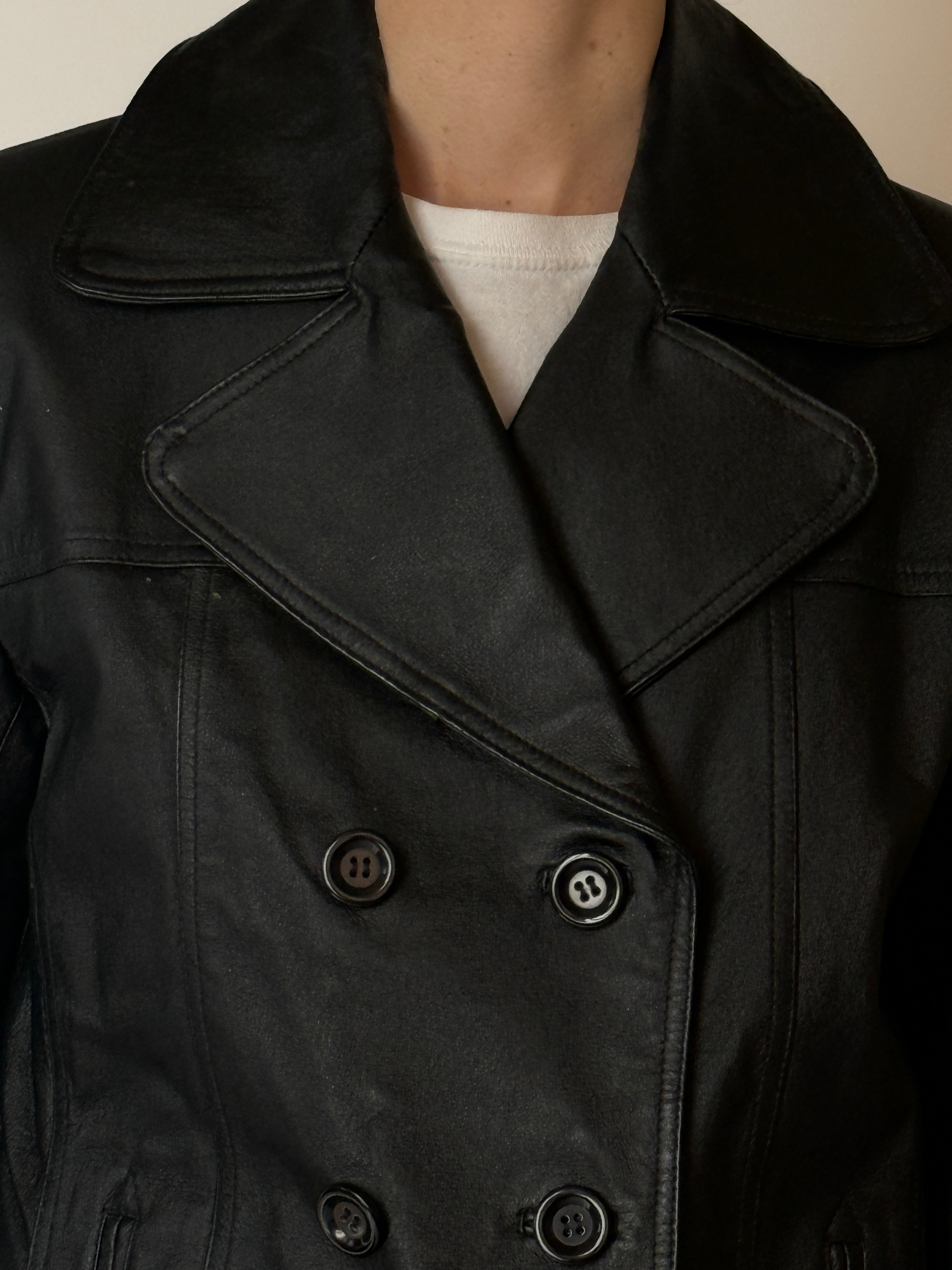 Vintage leather jacket featuring a double-breasted front and classic tailoring in black detail