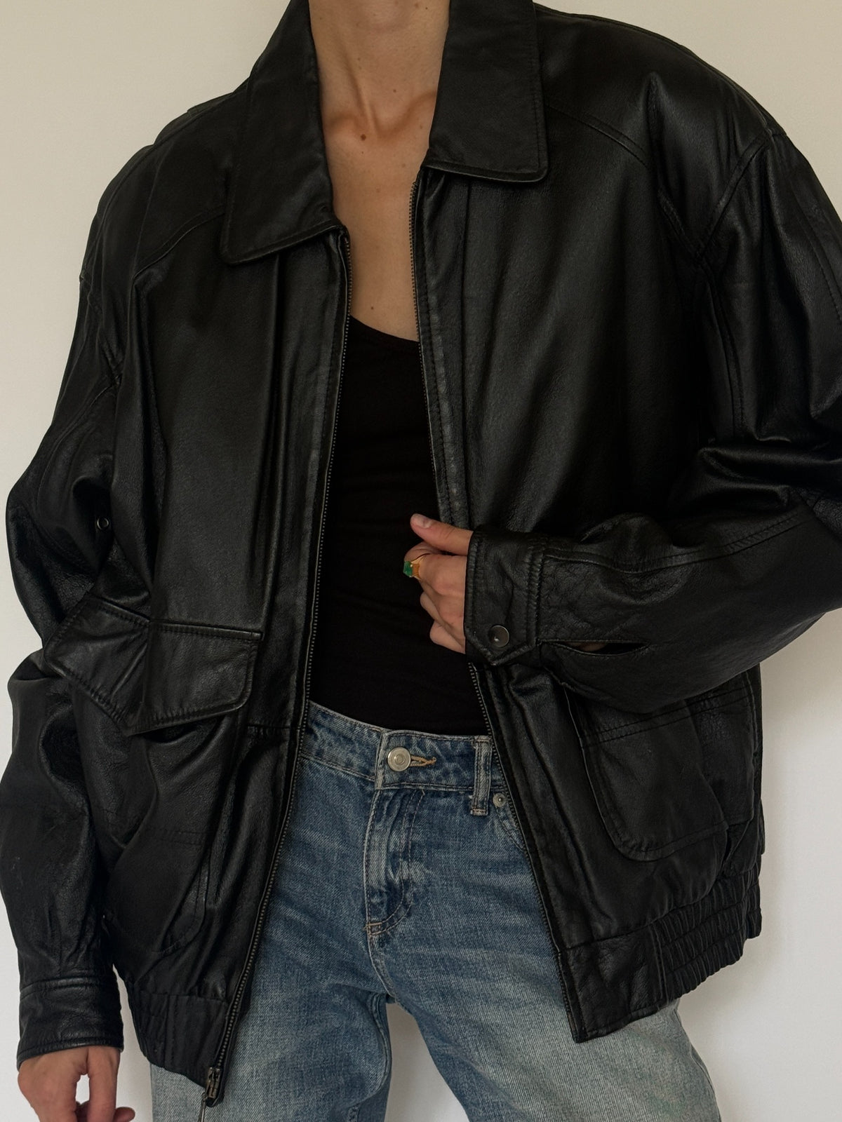 Vintage oversized leather bomber jacket black angled front view