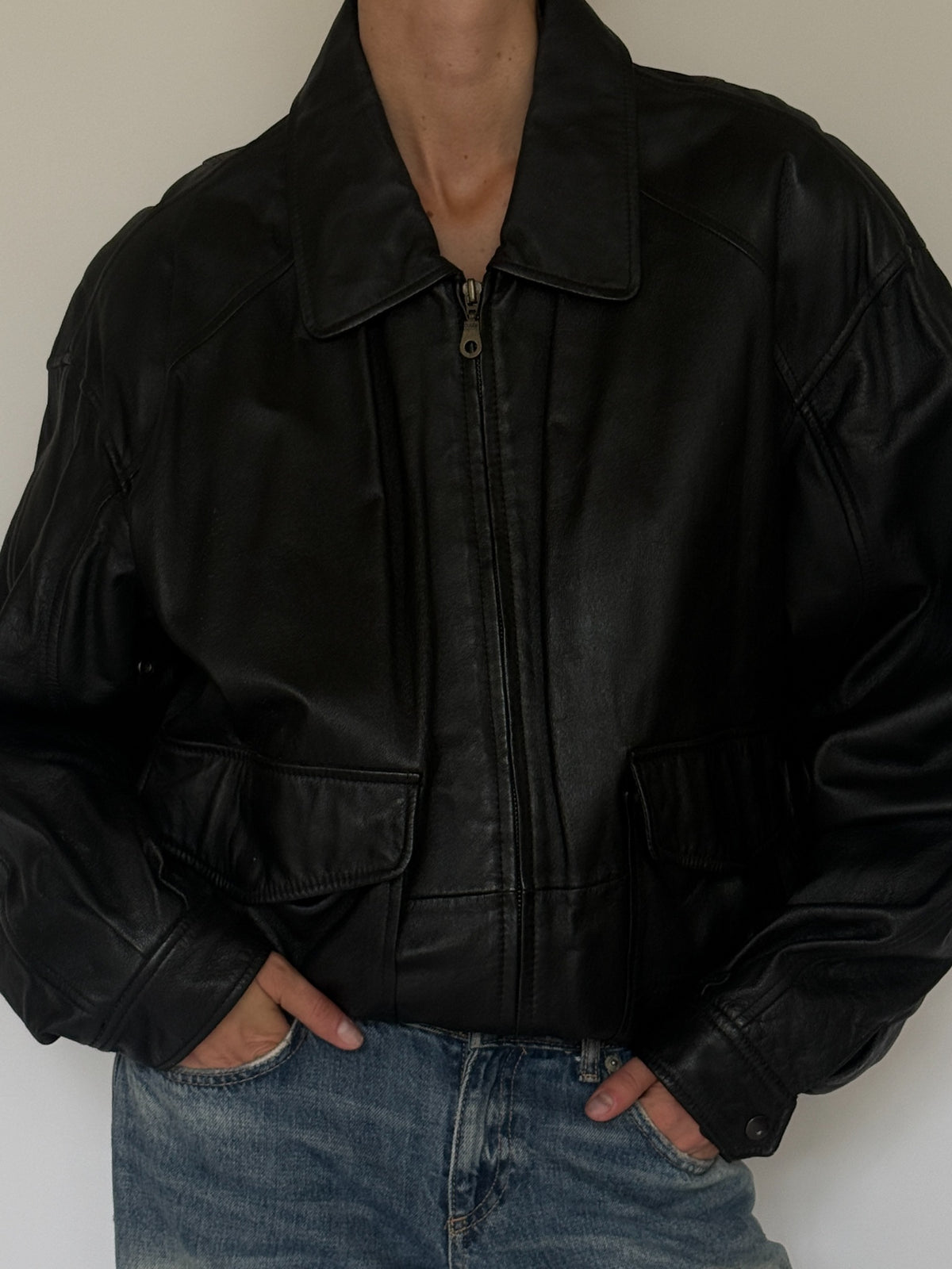 Vintage black leather bomber jacket pocket and cuff detail