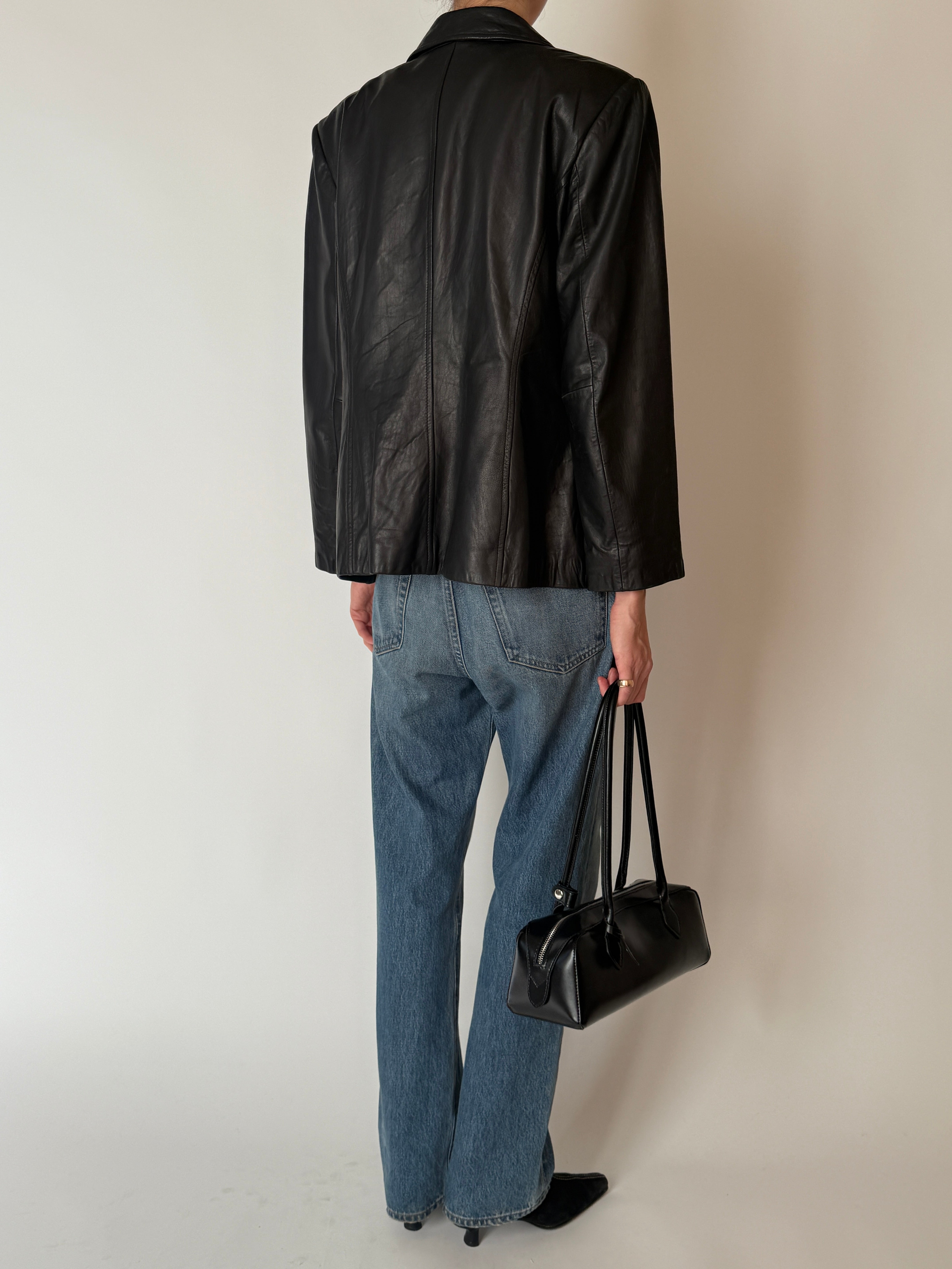 Back view of vintage black leather jacket